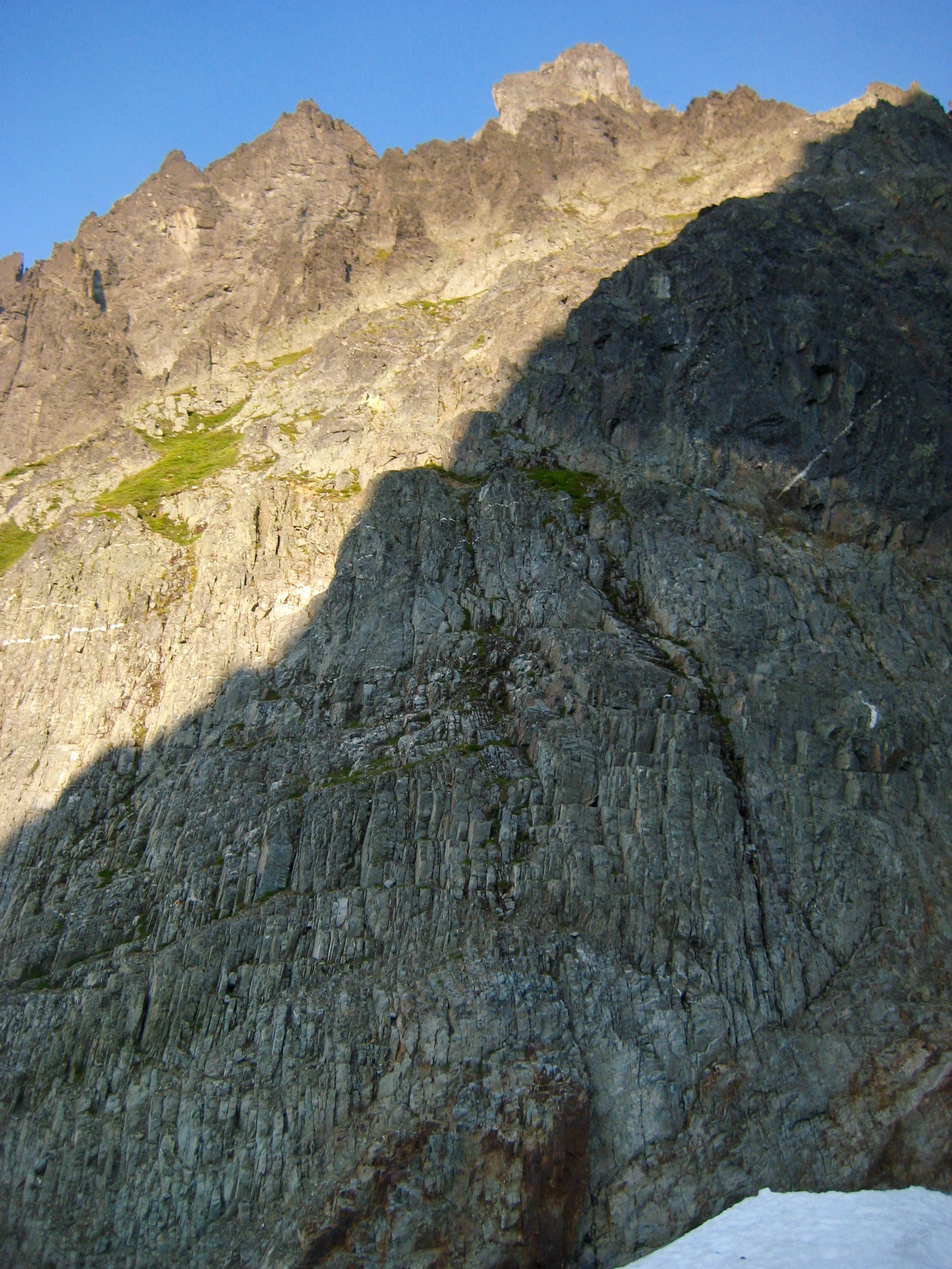 sunlight hitting the steep, rocky east slope of Johannesburg Mountain in the North Cascades Mountains
