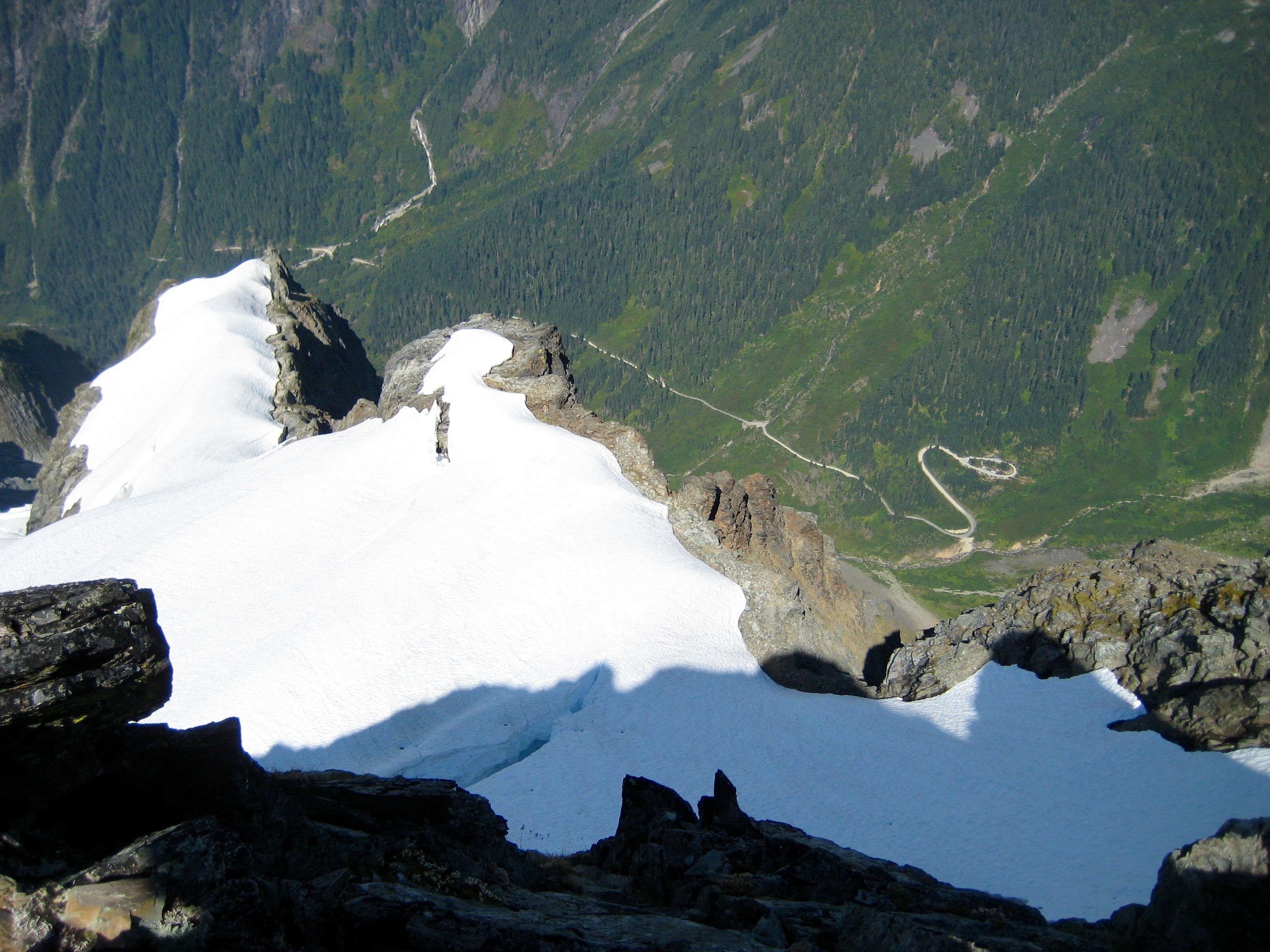 Looking down on large snow field and Cascade River Road from the summit of Johannesburg Mountain