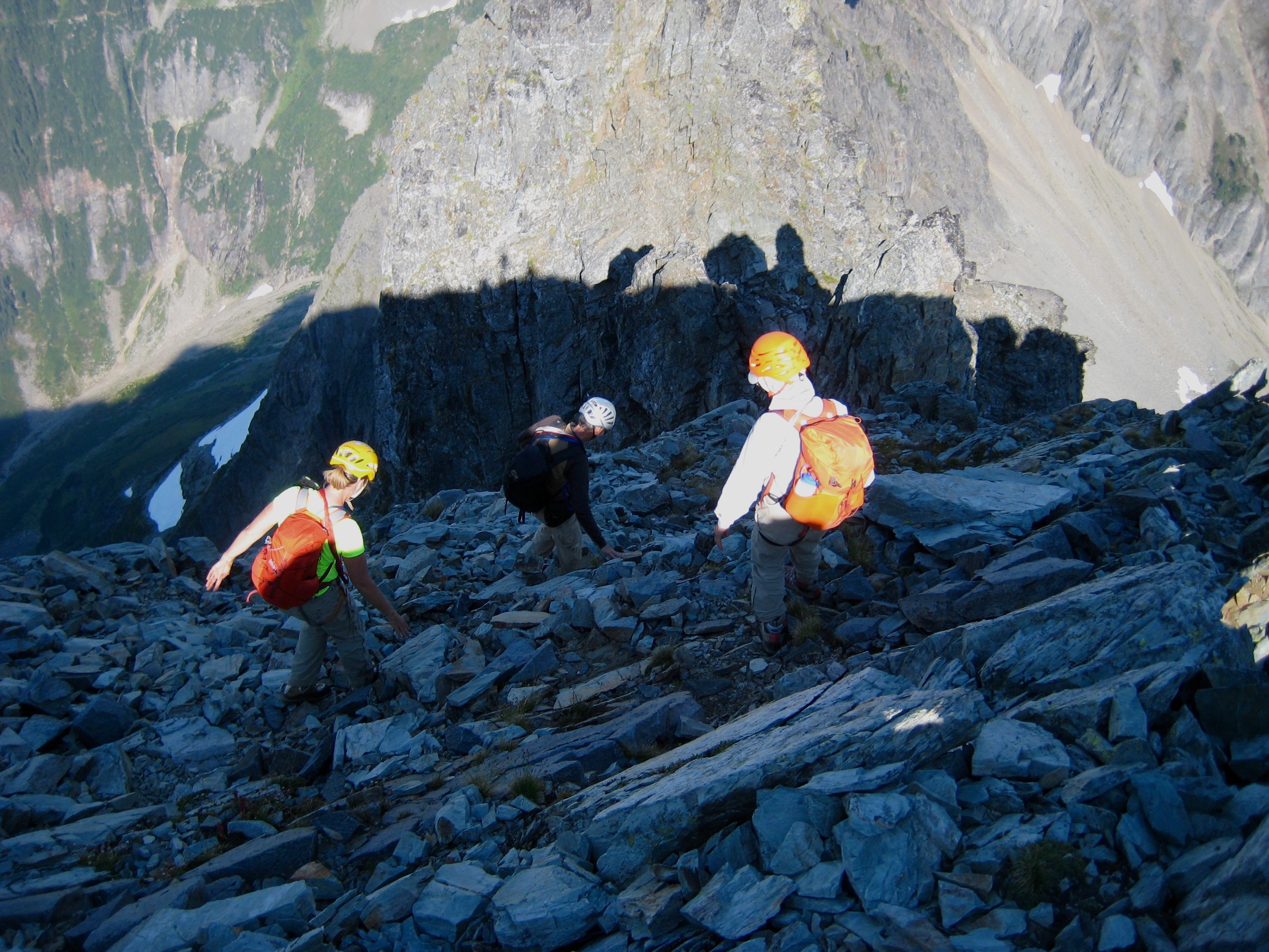 mountain climbers down climbing rocky slopes as the sun is setting on Johannesburg Mountain in North Cascades National Park