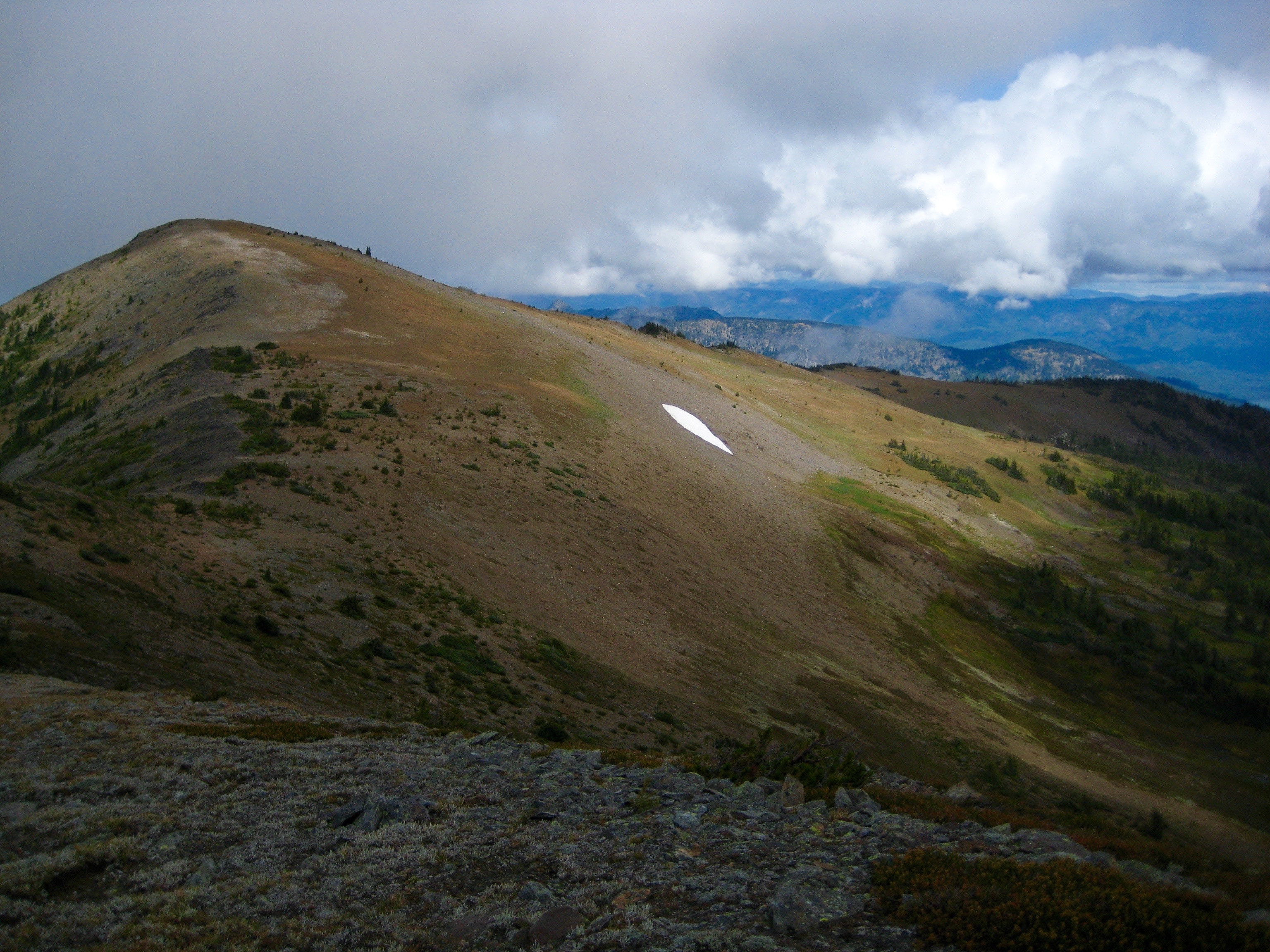 evening light on Mount Baldy along the Chiwaukum Traverse with a single snow patch as seen from McWaukum Pass in the Alpine Lakes Wilderness