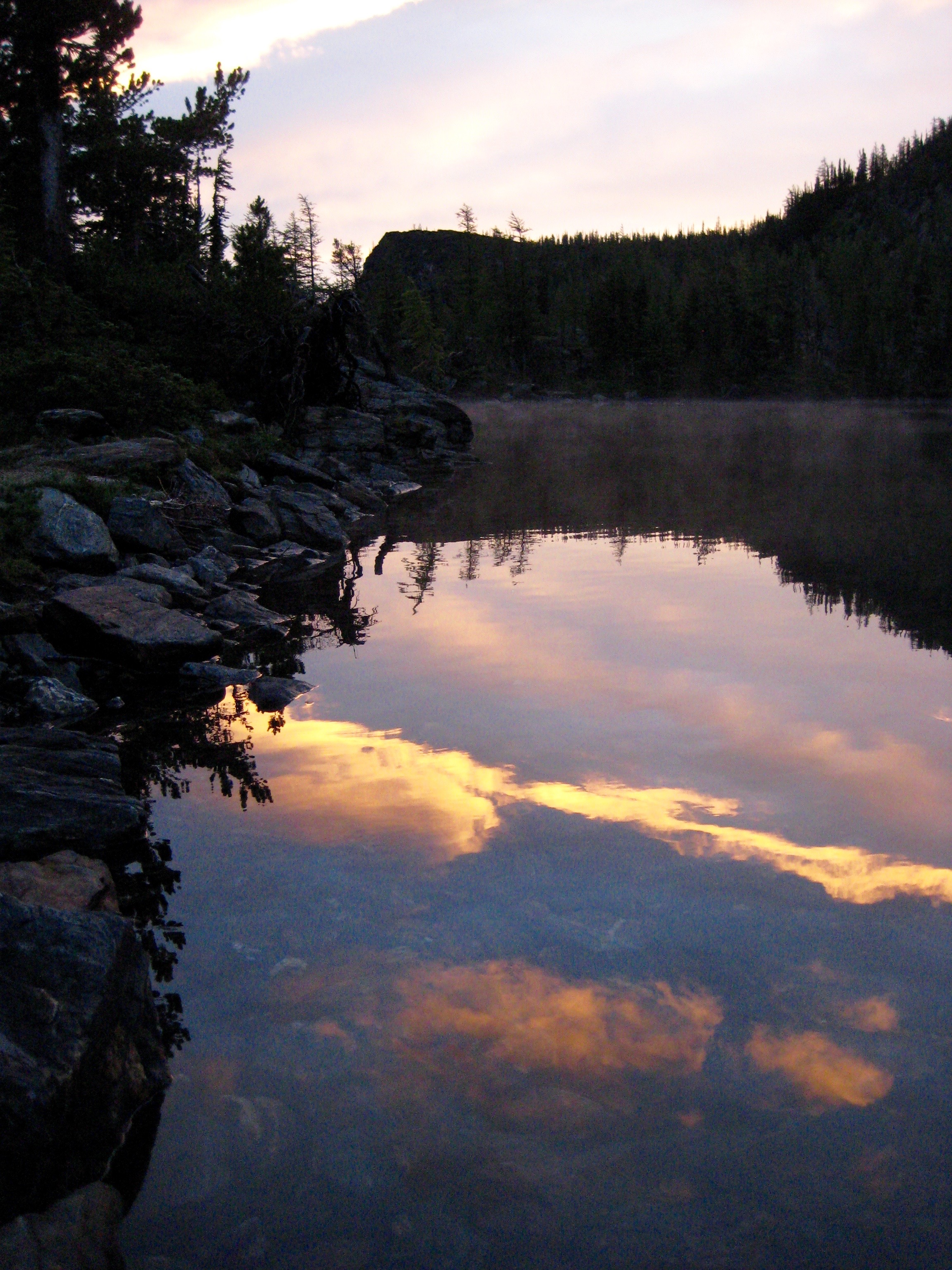 morning sun on the still water of Larch Lake in the Chiwaukum Mountains in the Alpine Lakes WIlderness