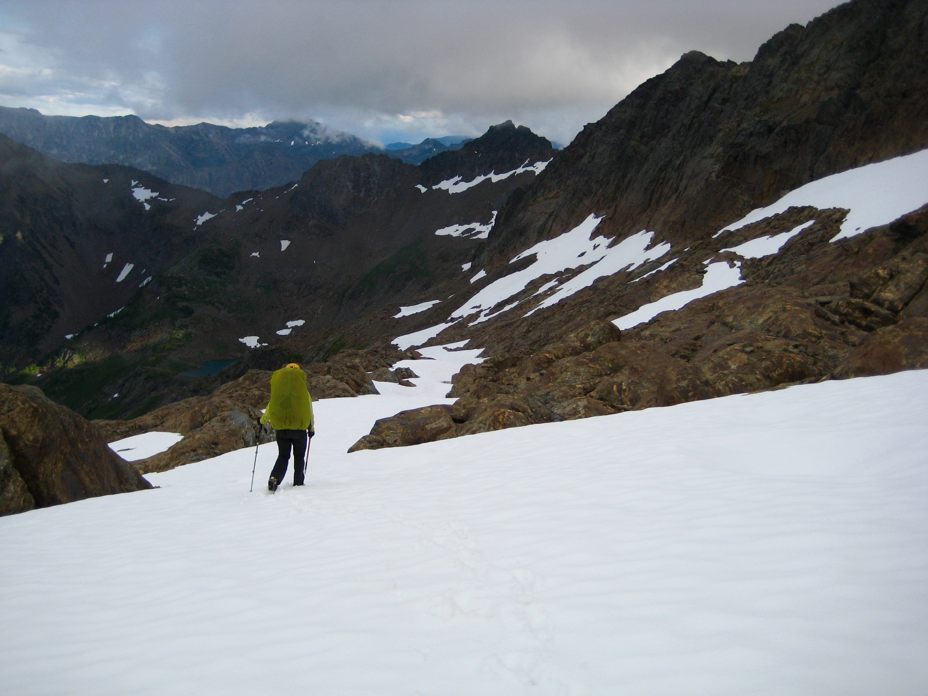 mountain climber plunge stepping a snow field descending from Big Chiwakum Peak in the Alpine Lakes WIlderness