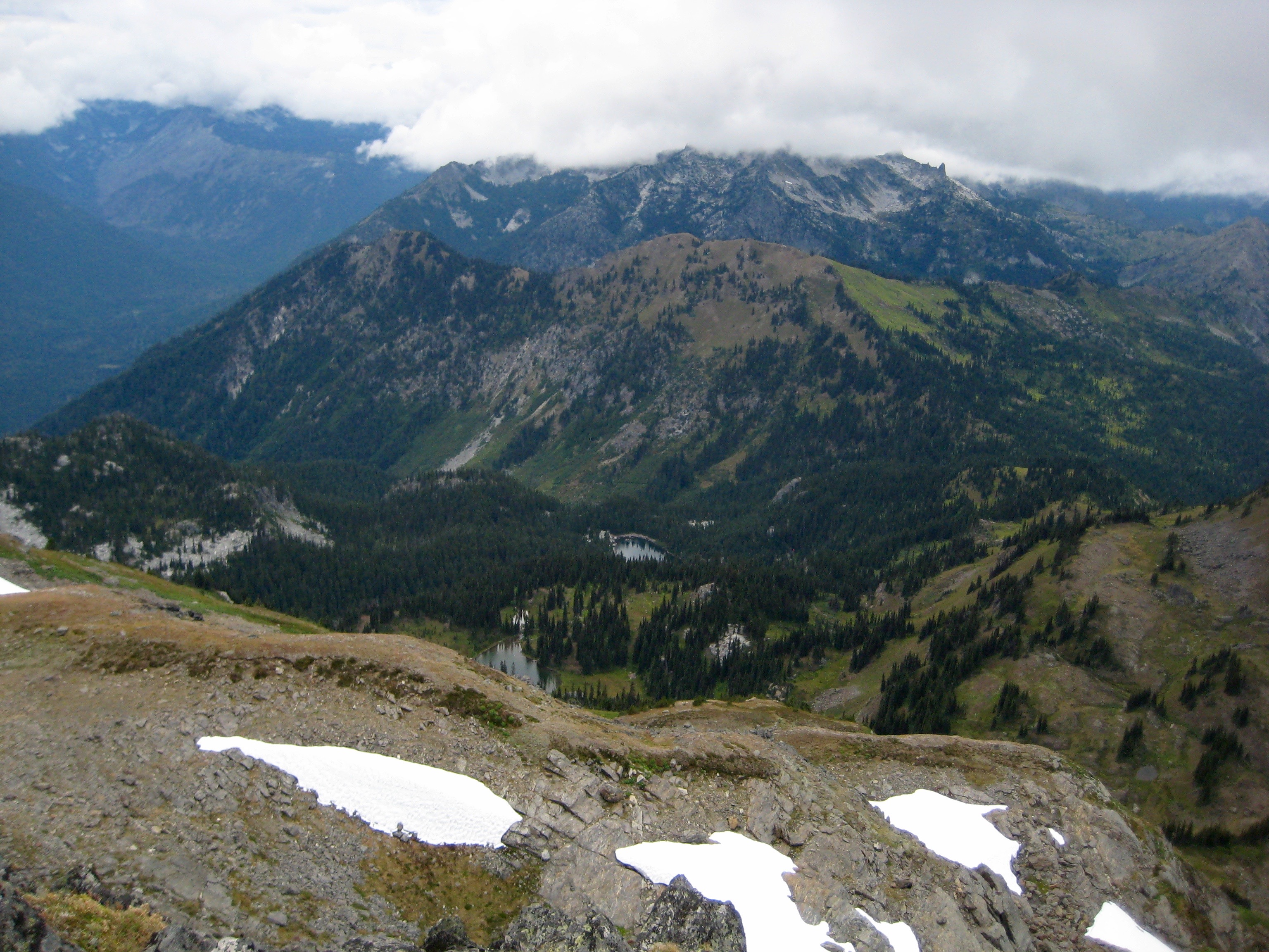 Chiwaukum Mountains with Lake Margaret and Lake Mary with linguring snow patches as seen from Ladies Peak in the Alpine Lakes Wilderness