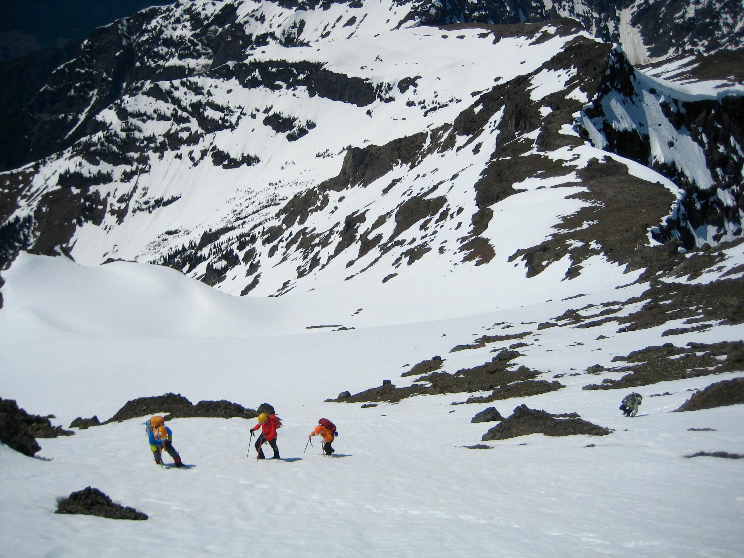 mountain climbers booting up snow field on the Southwest slope of Silvertip Mountain in the Sumallo Mountains BC Canada