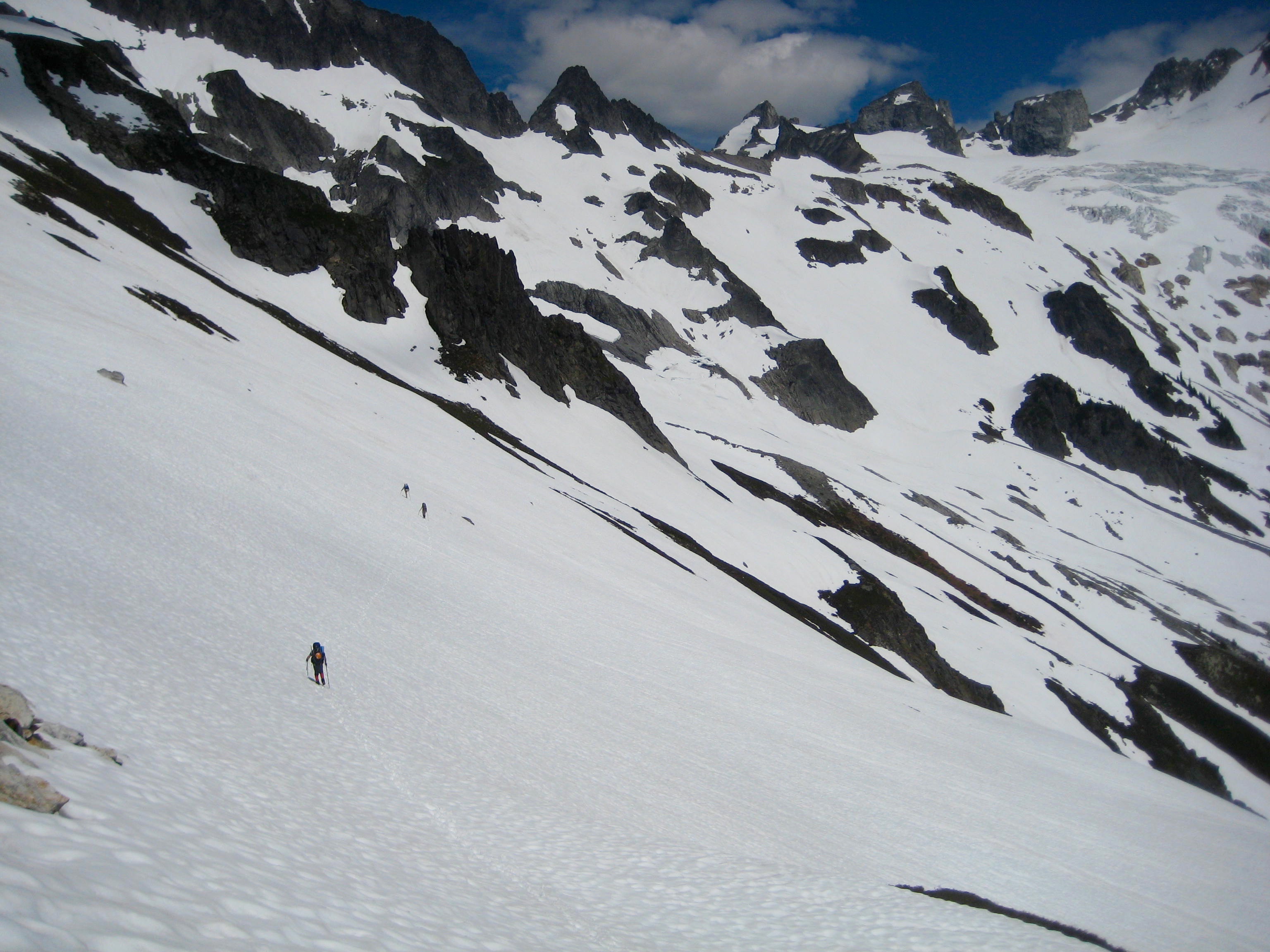 mountain climbers traversing snow fields on the way to the Dome Glacier and Dome Peak in the Ptarmigan Mountains