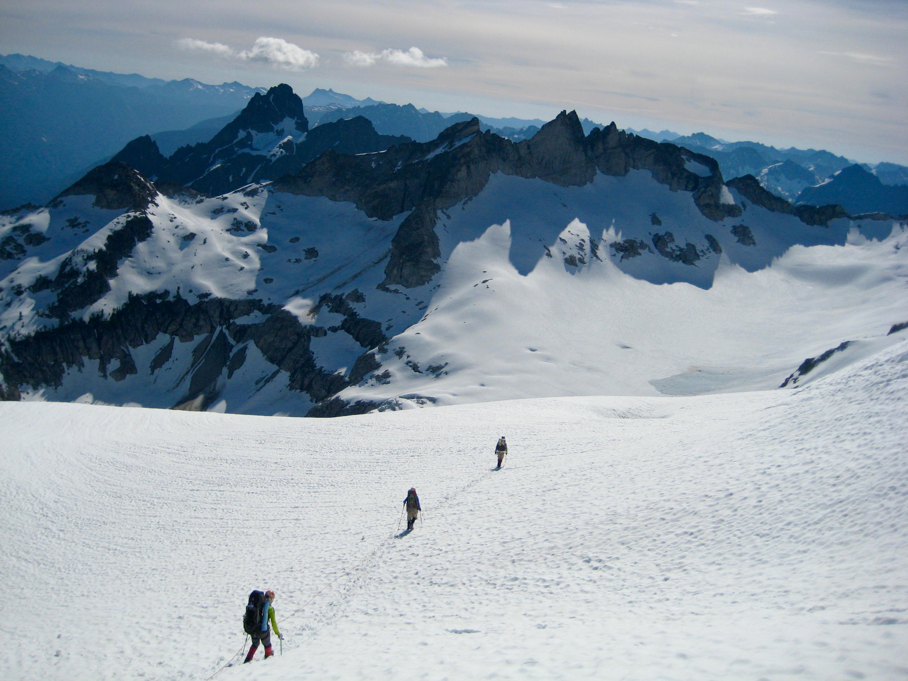 looking down on roped mountain climbers descending the Chikamin Glacier towards Gunsight Peak in the Glacier Peak Wilderness