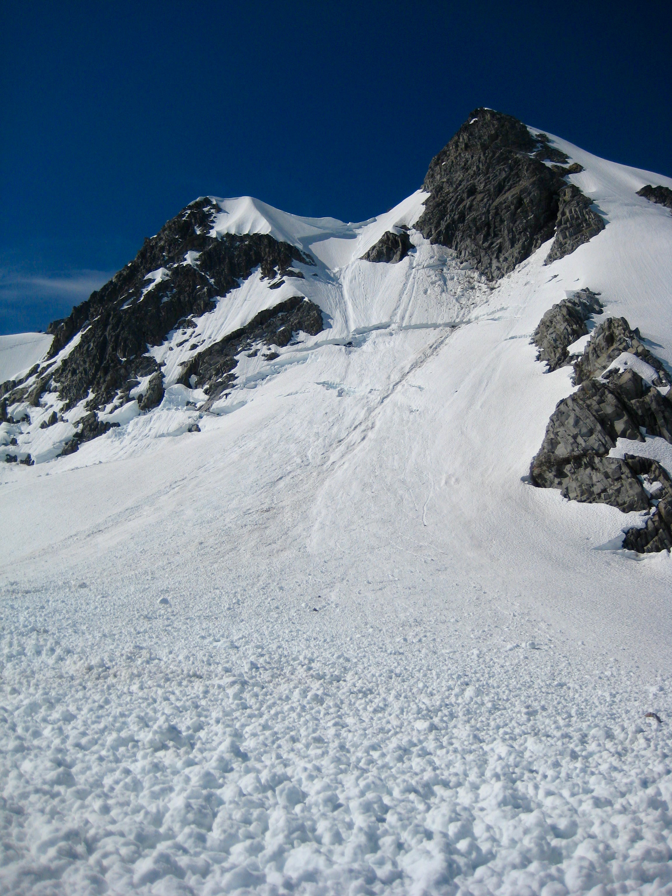 Sinister Peak above an avalanche shoot in the Ptarmigan Mountains