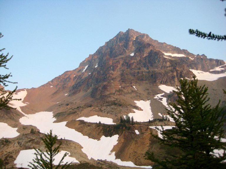The triangular summit of Black Peak towers over Wing Lake in the Ragged Ridge Mountains in North Cascades National Park