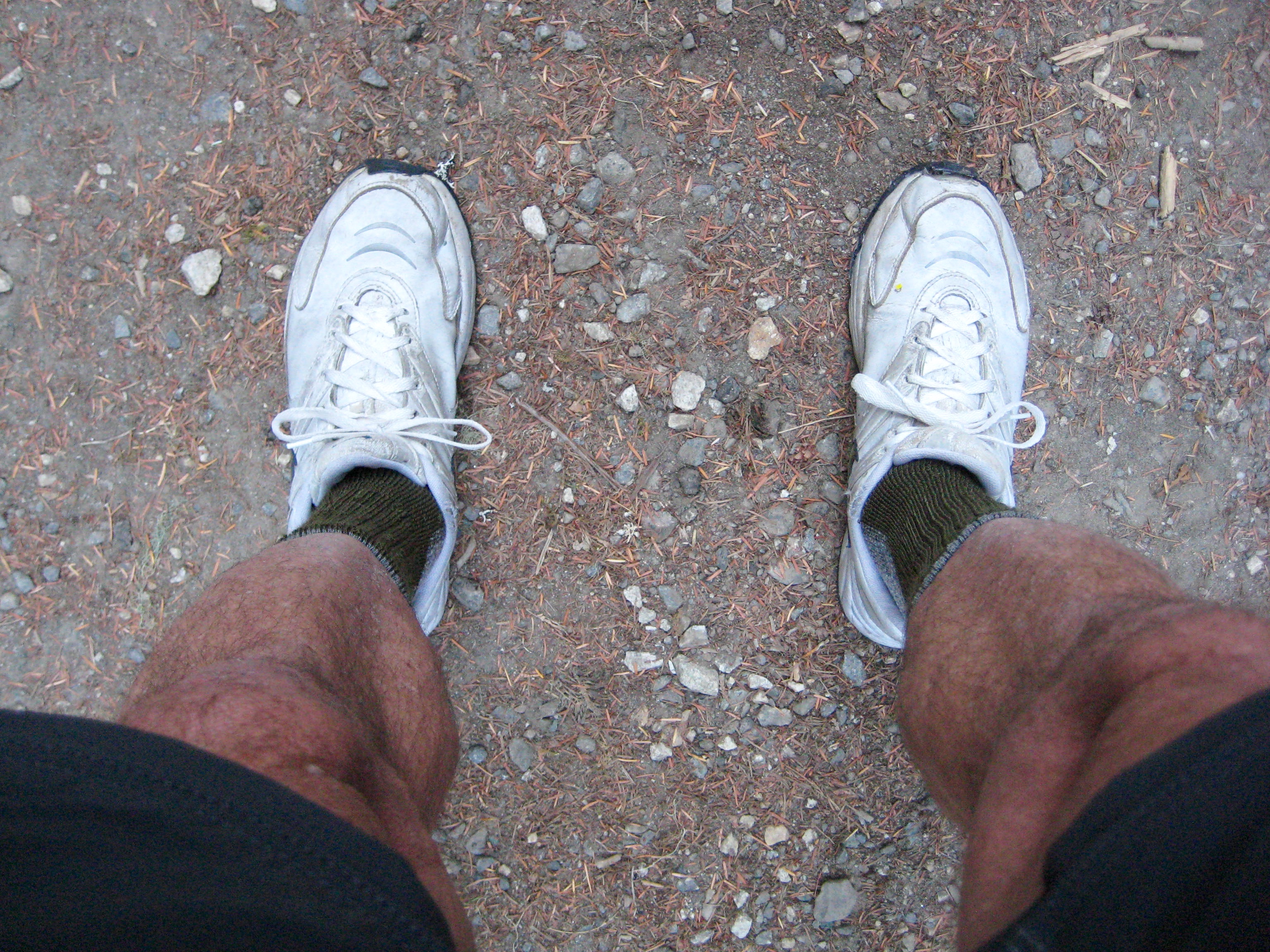 looking down at Vintage White Nikes on mountain climbers feet