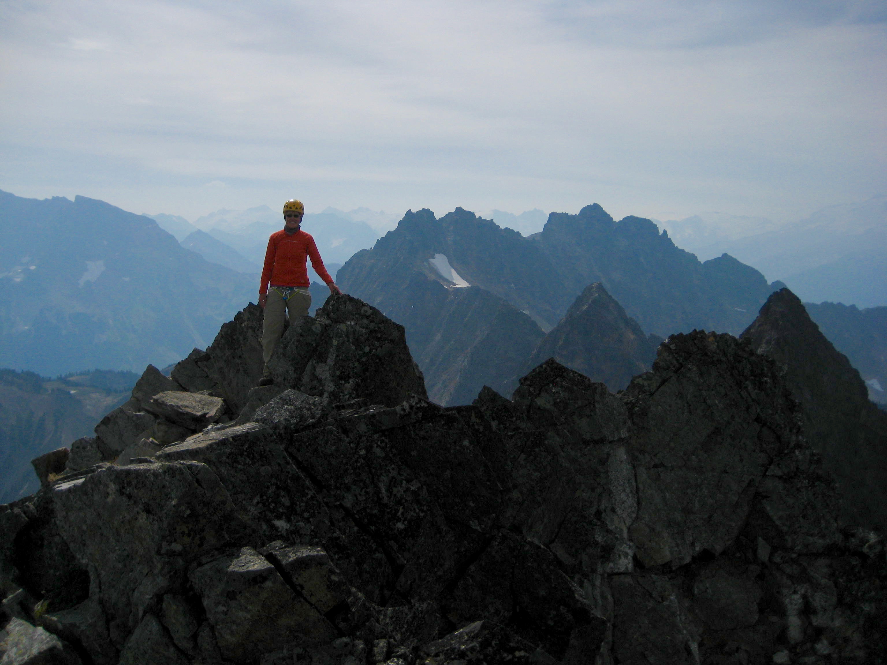 mountain climber on the summit of Sitting Bull Mountain looking at near by Plummer Mountain
