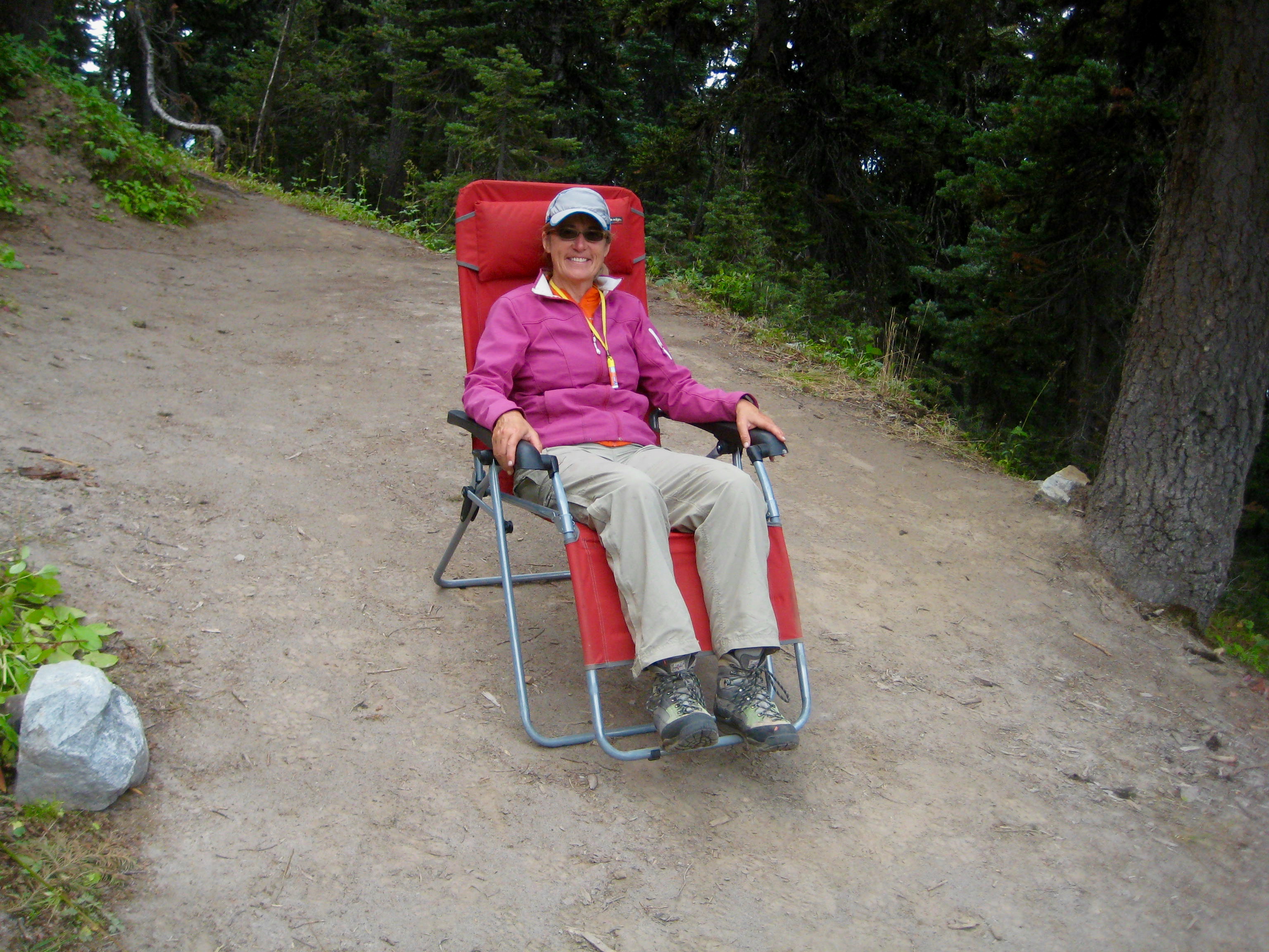 mountain climber relaxing in a lounge chair at Lady Camp in Glacier Peak WIlderness