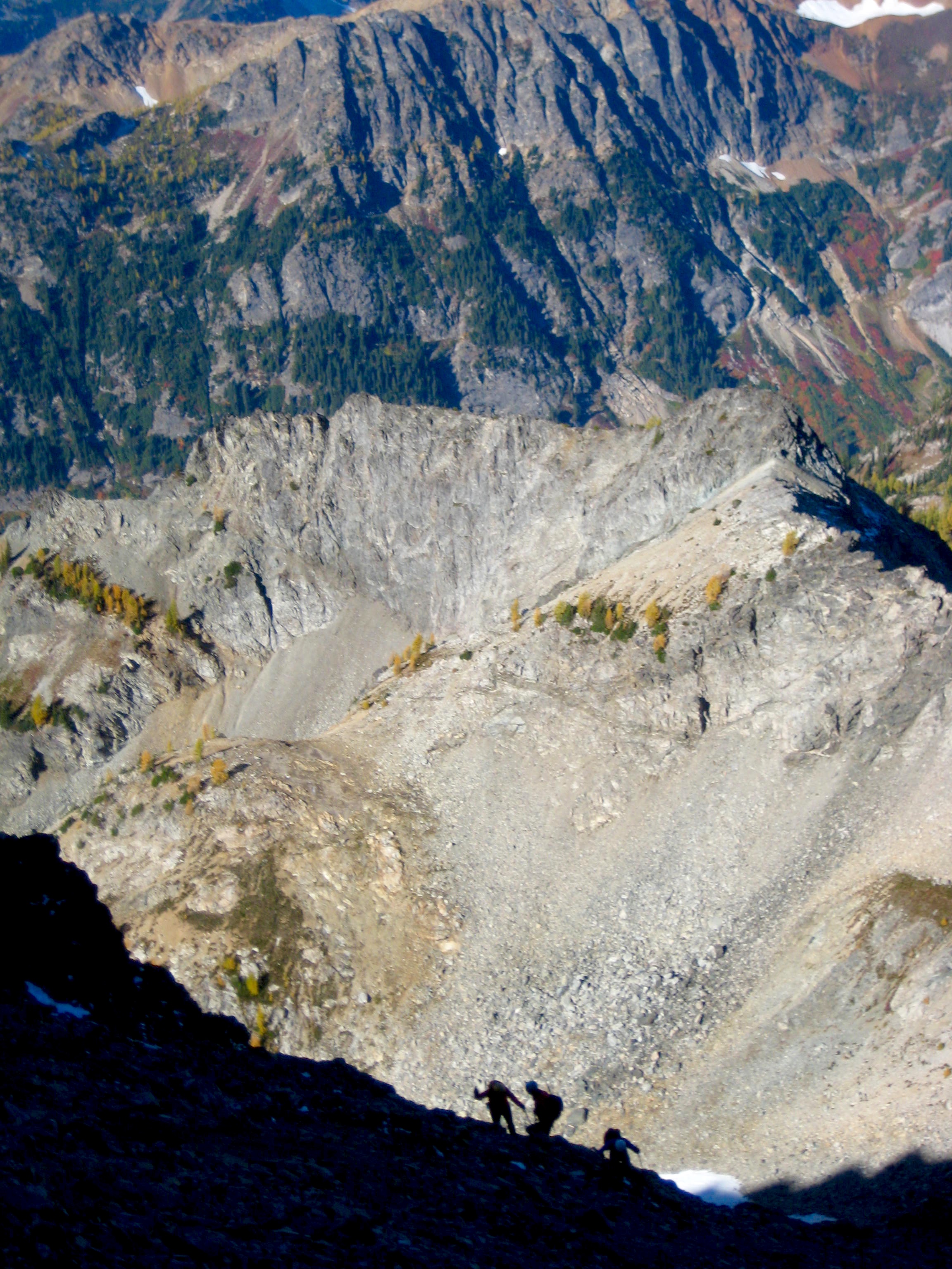 mountain climbers scrambling the rocky boulders on the west slope on Seven-Fingered Jack in the Entiat Mountains
