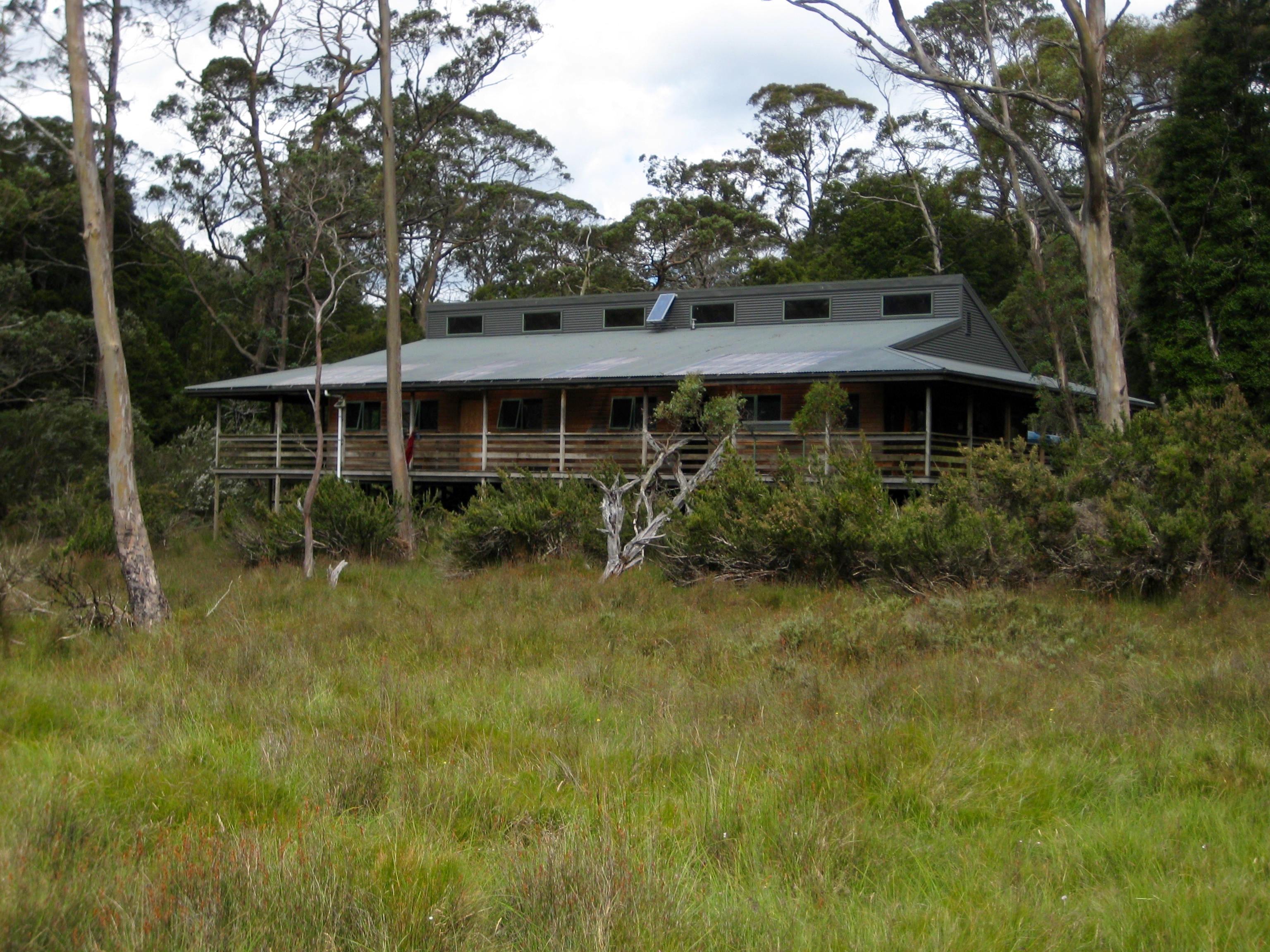 Hikers arriving Pelion Hut on the Overland Track