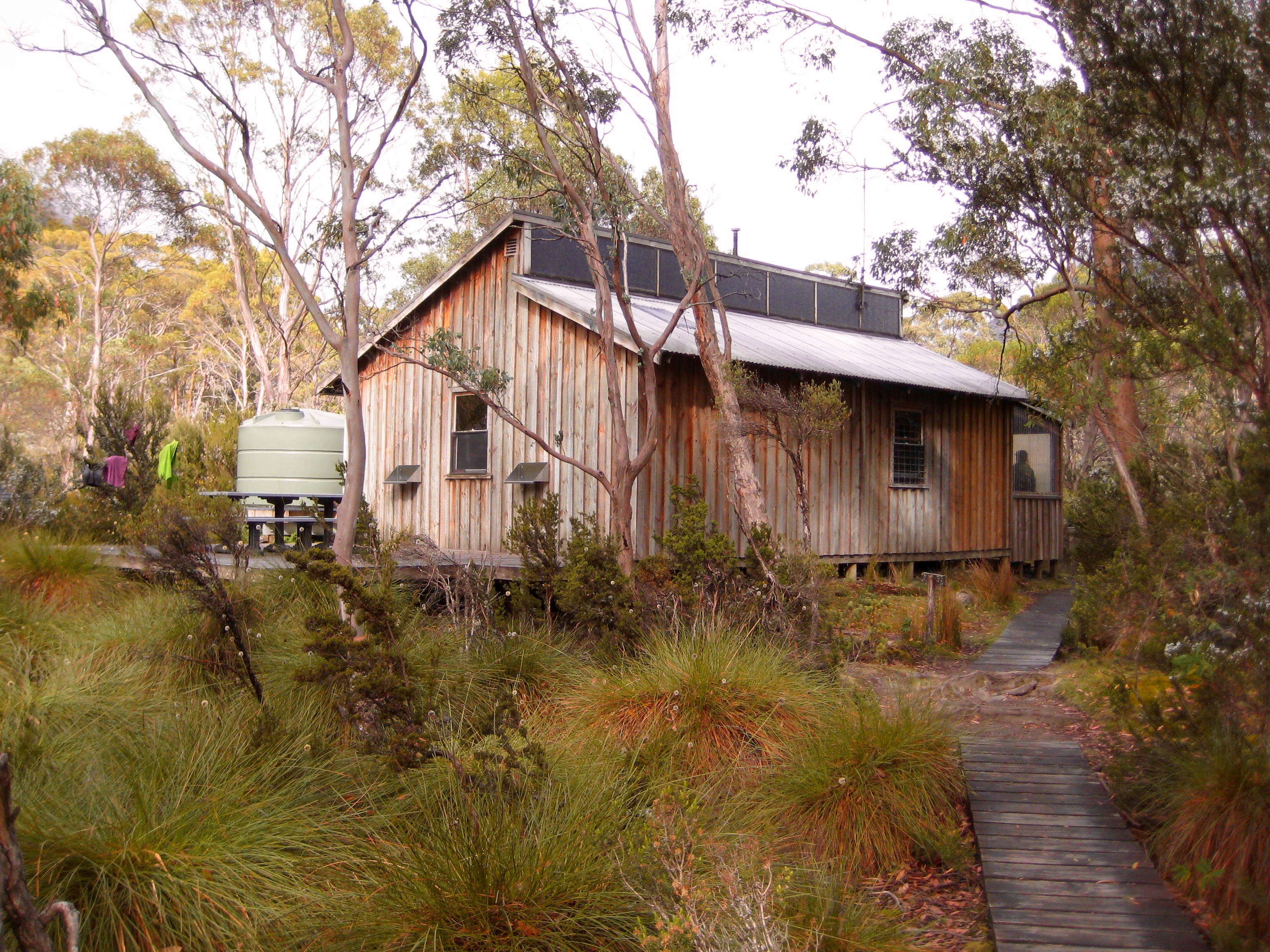 trekker arriving Kia Ora Hut on the Overland Track