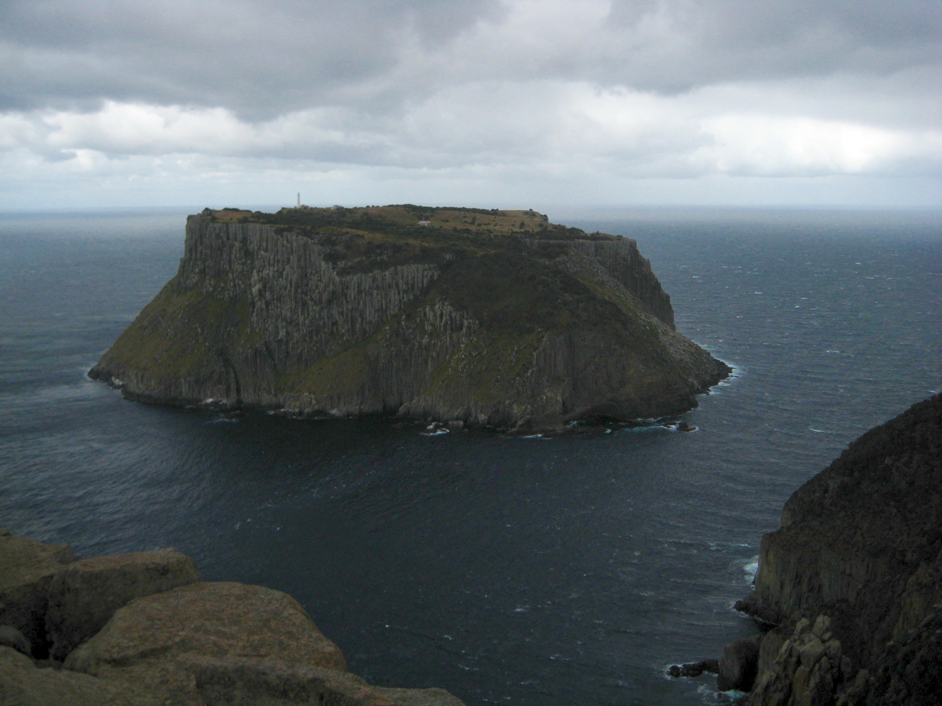 storm clouds over Tasman Island near the tip of Cape Pillar on the Three Capes Track in Tasmania