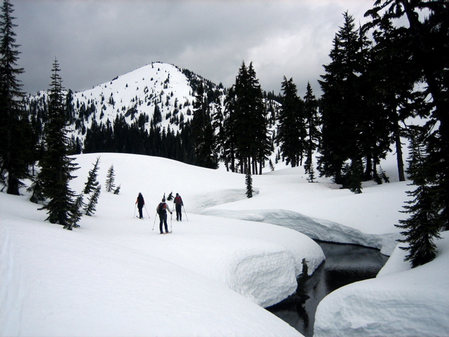 A creek winds through a snowy landscape during Nason-Smith Ski Traverse