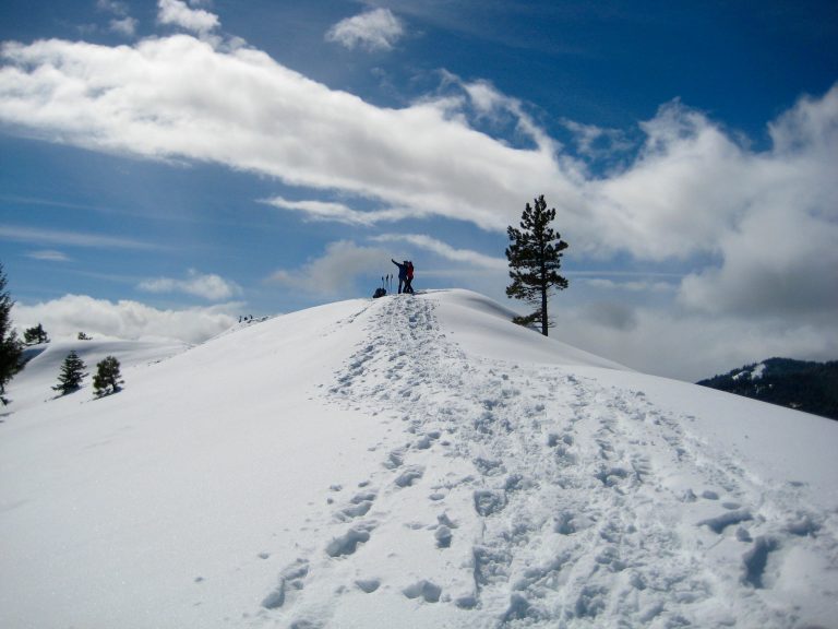 Snowshoe tracks lead up a snowy ridge to the summit of Teanaway Butte