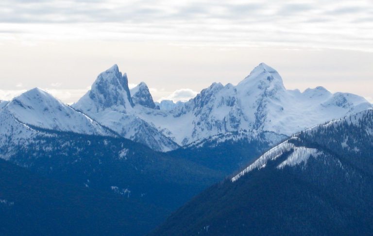 The two rugged peaks of Hozomeen Mountain stand above a snowy skyline