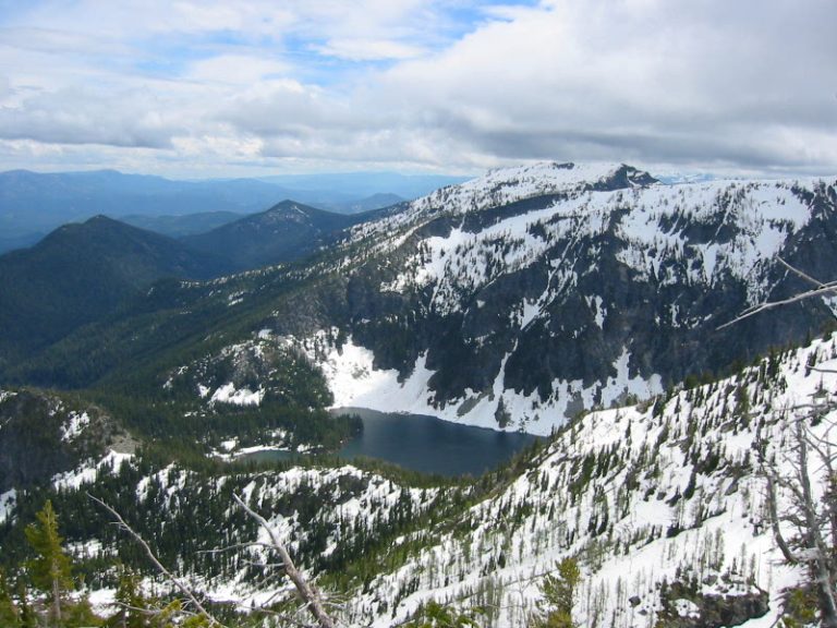 Looking down at Schaefer Lake in a snow-covered bowl from Dysprosium Peak