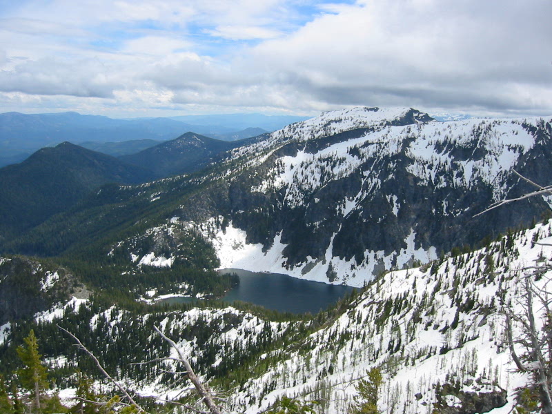 Looking down at Schaefer Lake in a snow-covered bowl from Dysprosium Peak