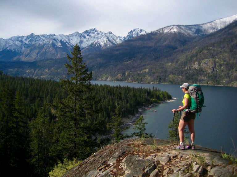 Hiker at Hunts Bluff on the Lakeshore Trail over looking Lake Chelan