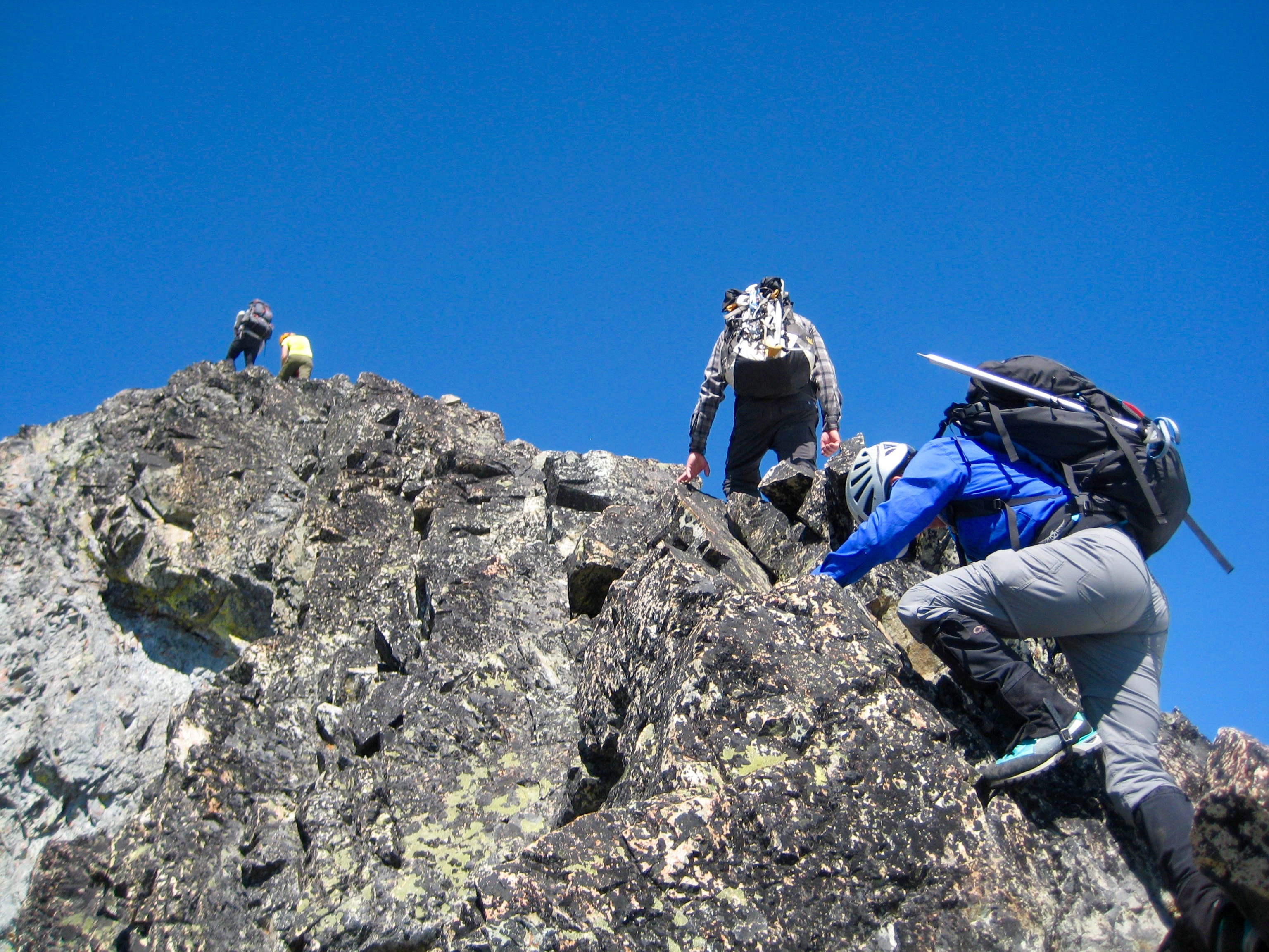 mountain climbers scrambling the rocky ridge of Robinson Mountain in the Pasayten Wilderness