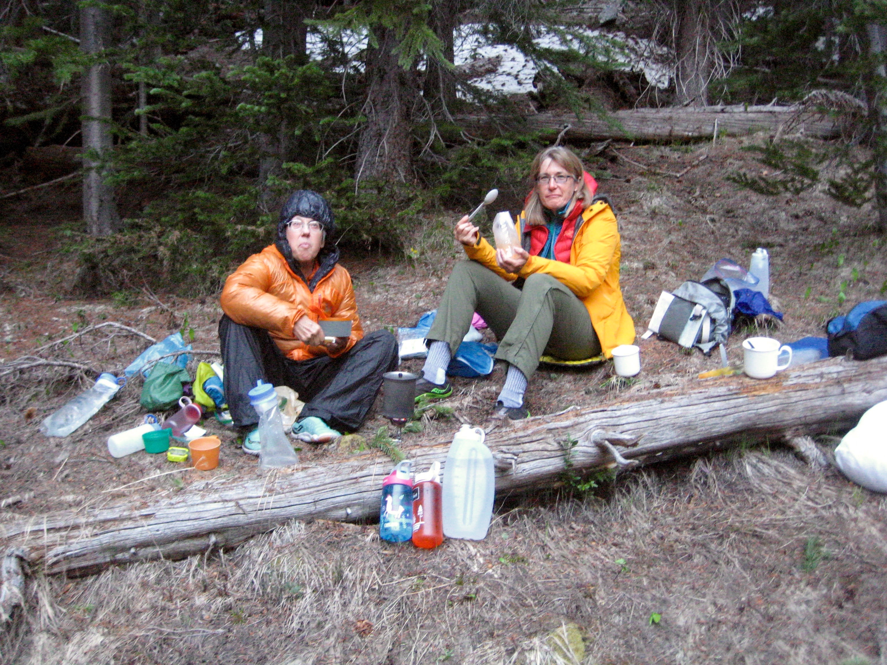 mountain climbers having dinner in a forest camp in the basin below Beauty Peak and Robinson Mountain in the Pasayten Wilderness