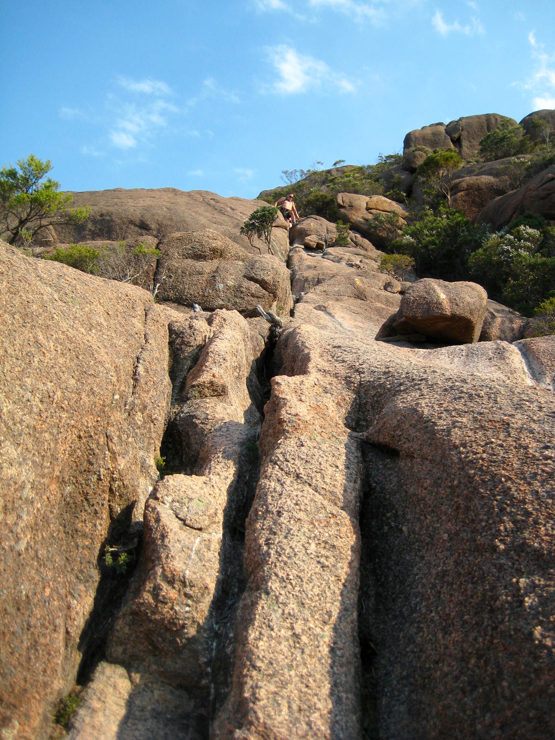 looking up giant rock crack high on the hiking trail to the summit of Mt Amos in Tasmania's Freycinet National Park