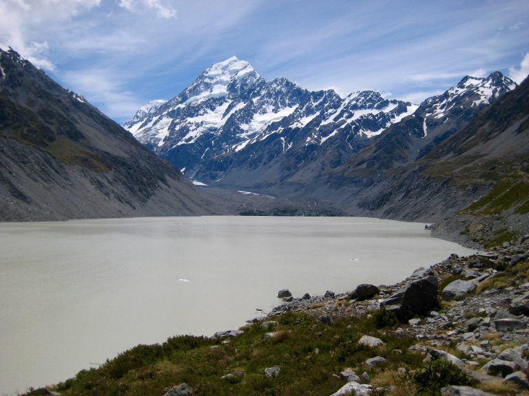 Mt Cook stands above the head of emerald green Hooker Lake in New Zealand