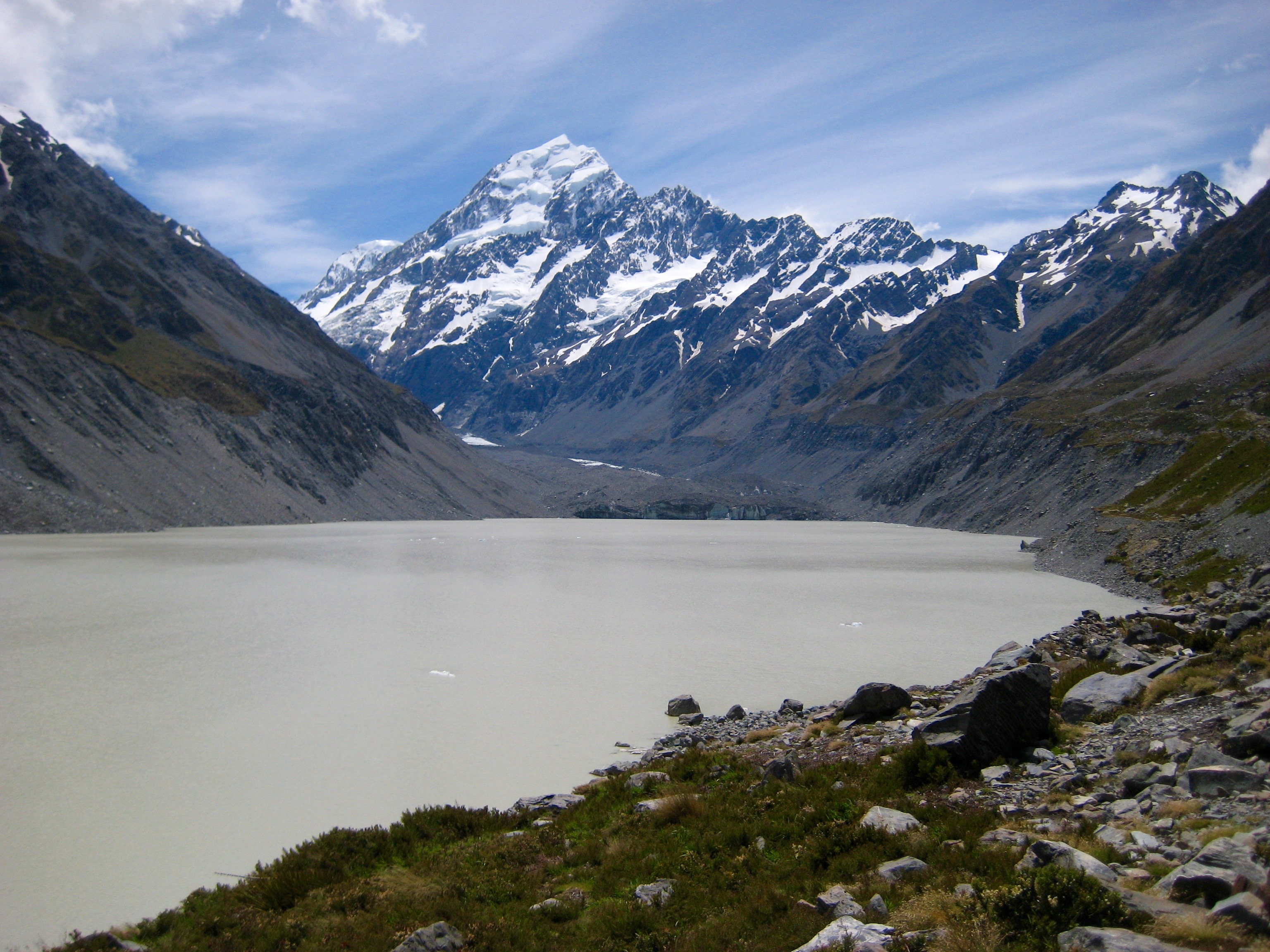 Mt Cook stands above the head of emerald green Hooker Lake in New Zealand
