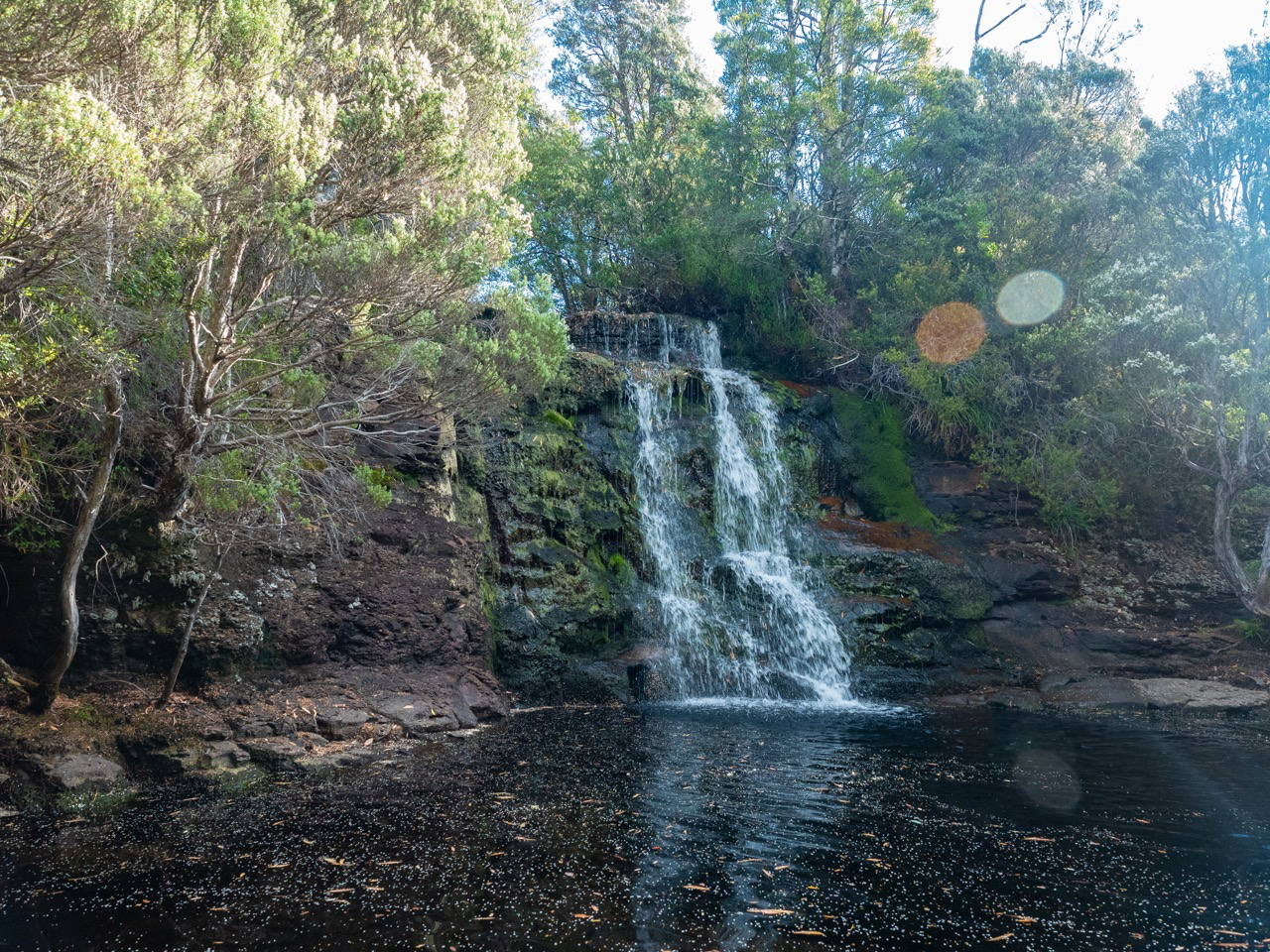 hikers washing off in swimming hole at Kia Ora Creek near camping huts