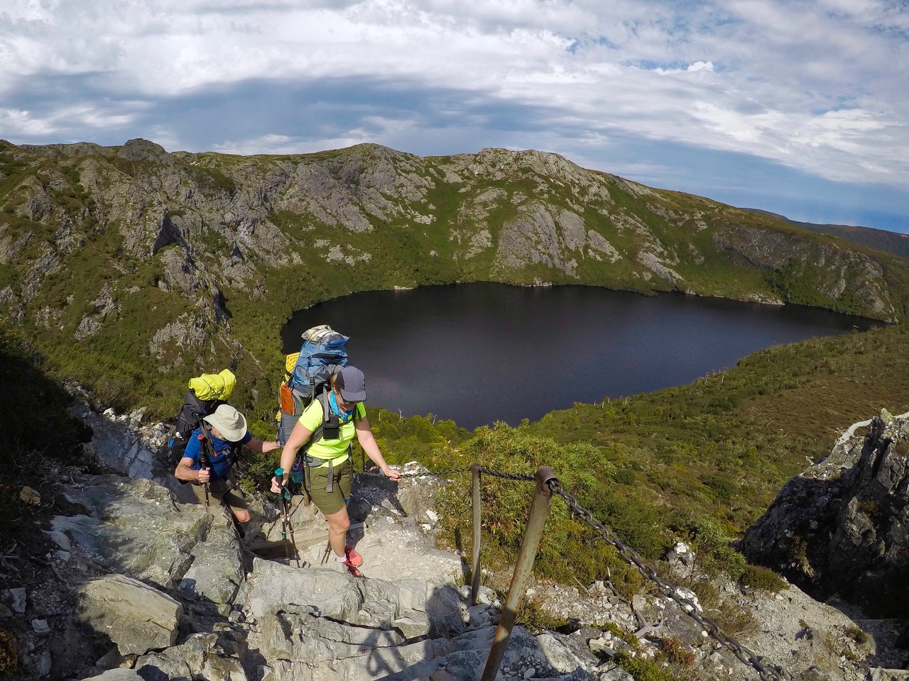 Hikers hiking above Crater Lake on the Overland Track