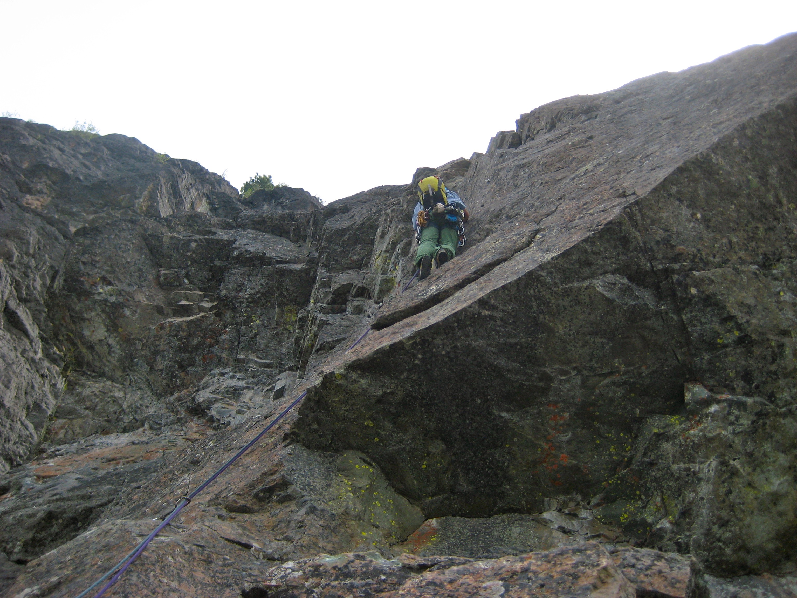 A rock climber scales a vertical cliff on Prime Rib route at Goat Wall in the Methow Valley