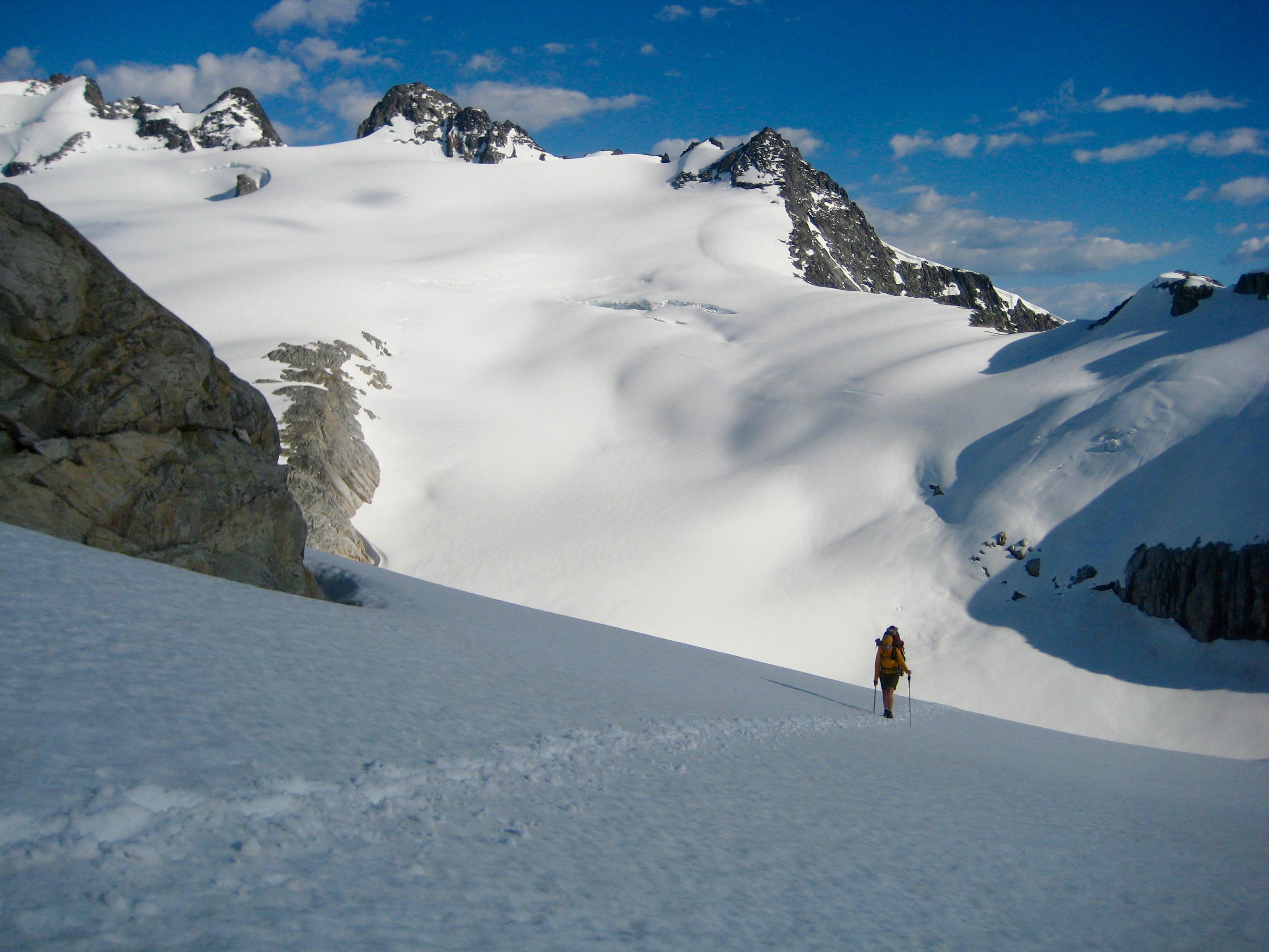 climbers high on the traverse of Whatcom Peak with Mt Challenger in the background