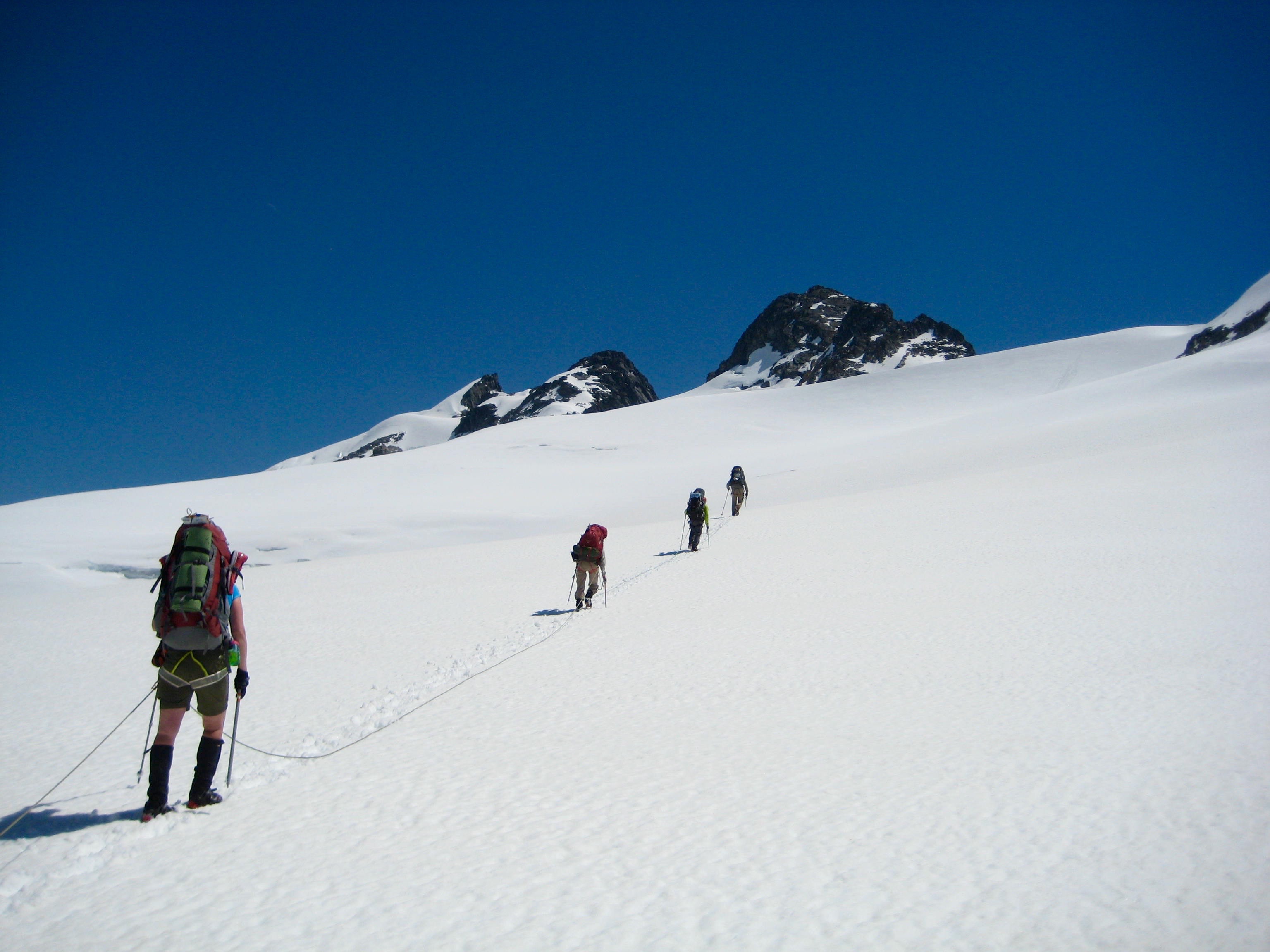 climbers roped together heading up the Challenger Glacier