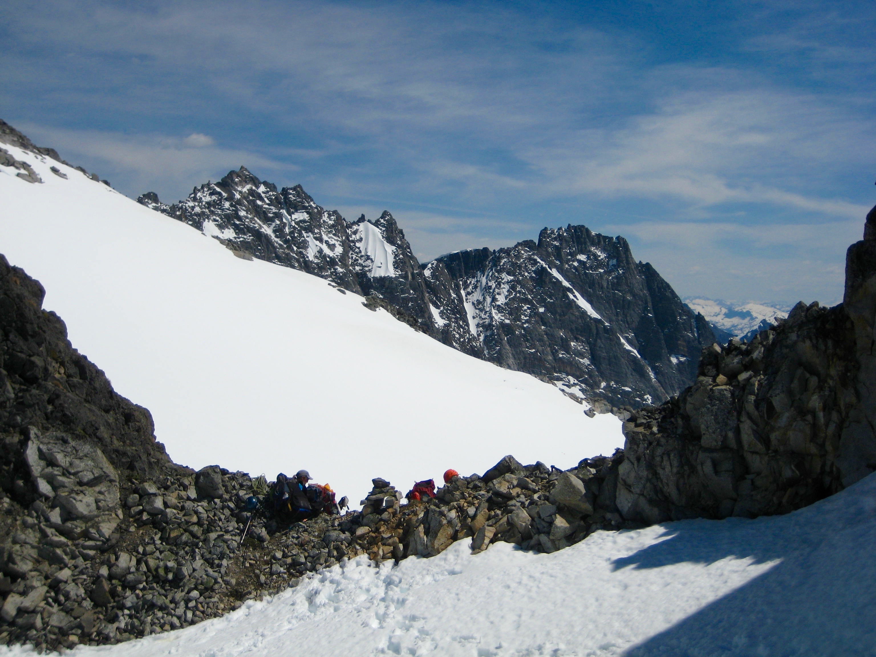 climbers taking a break at Solar Pass which is on the Mt Challenger ridge with views of mountain peaks