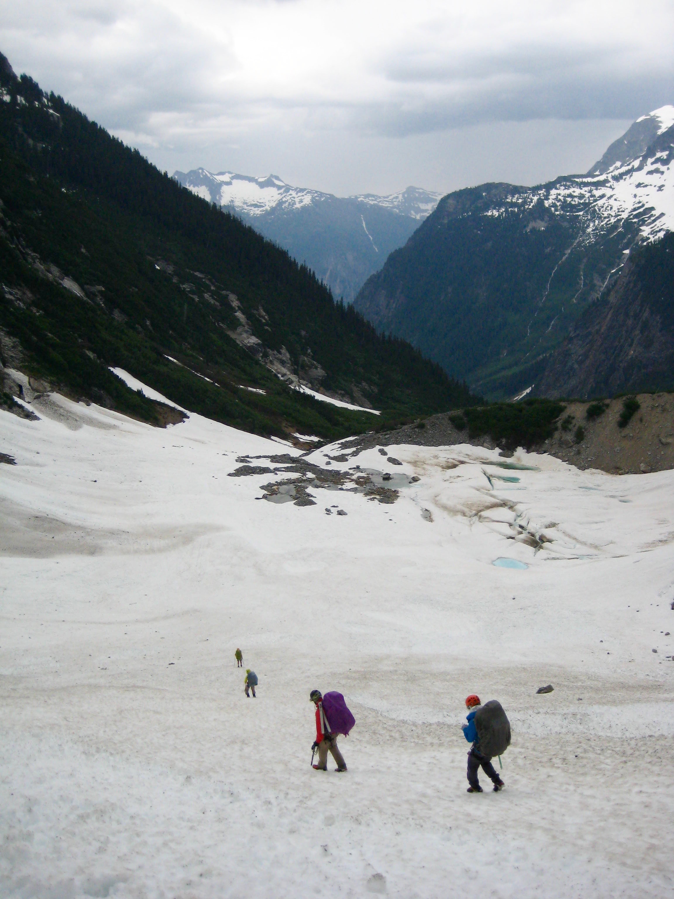 climbers plunging the snow to descend to McMillan Tarn