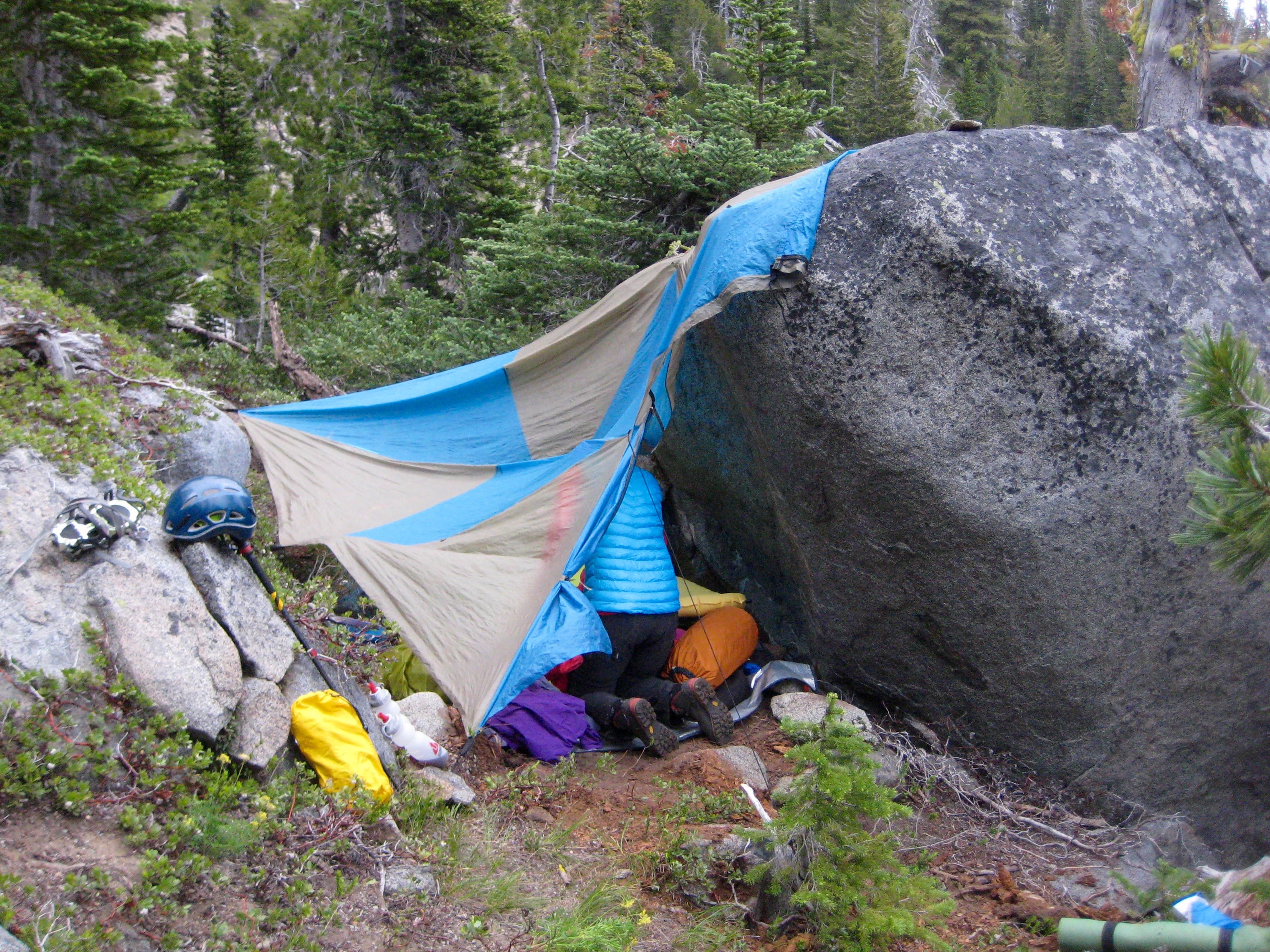 mountain climber's bivey site next to a giant boulder on the shoulder of Sherpa Peak in the Icicle Mountains