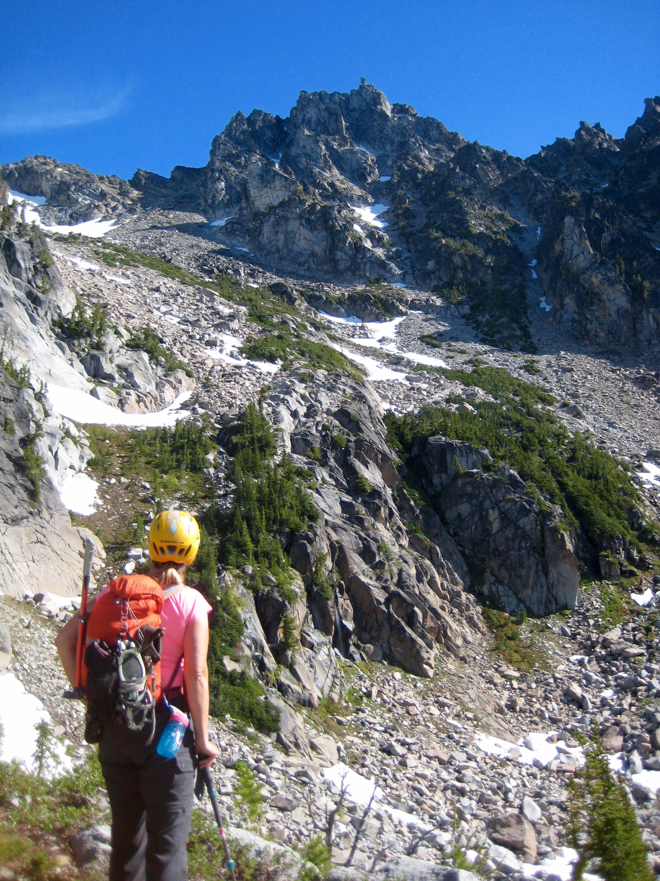 mountain climber scoping out the route up Sherpa Peak across scree fields and up gullies