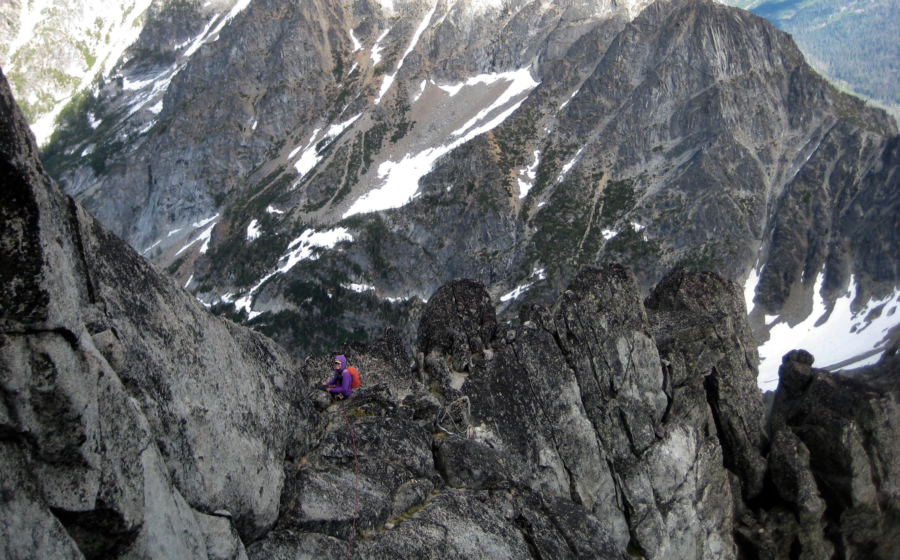 mountain climber belaying on the step rocky east ridge of Sherpa Peak in the Icicle Mountains