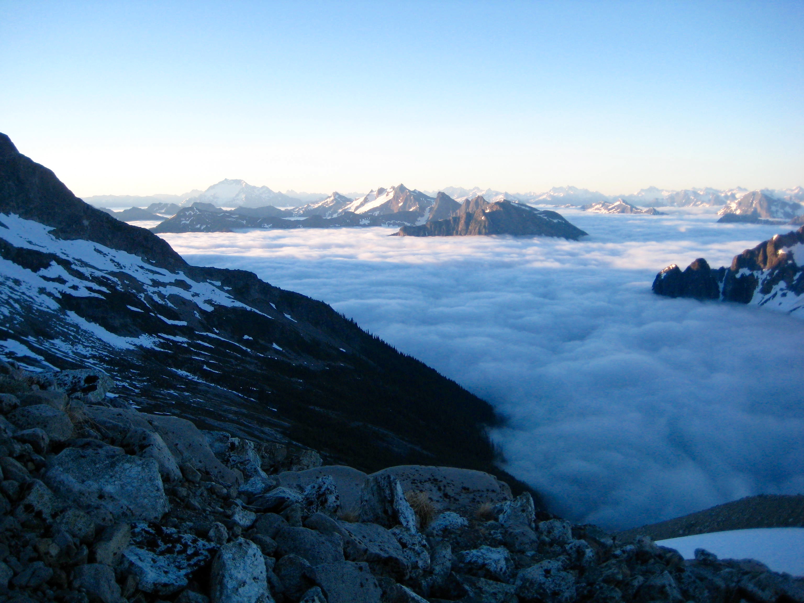 morning valley fog on the North Cascades with boulder field marking the base of the Redoubt Glacier in the American Chilliwack Mountains