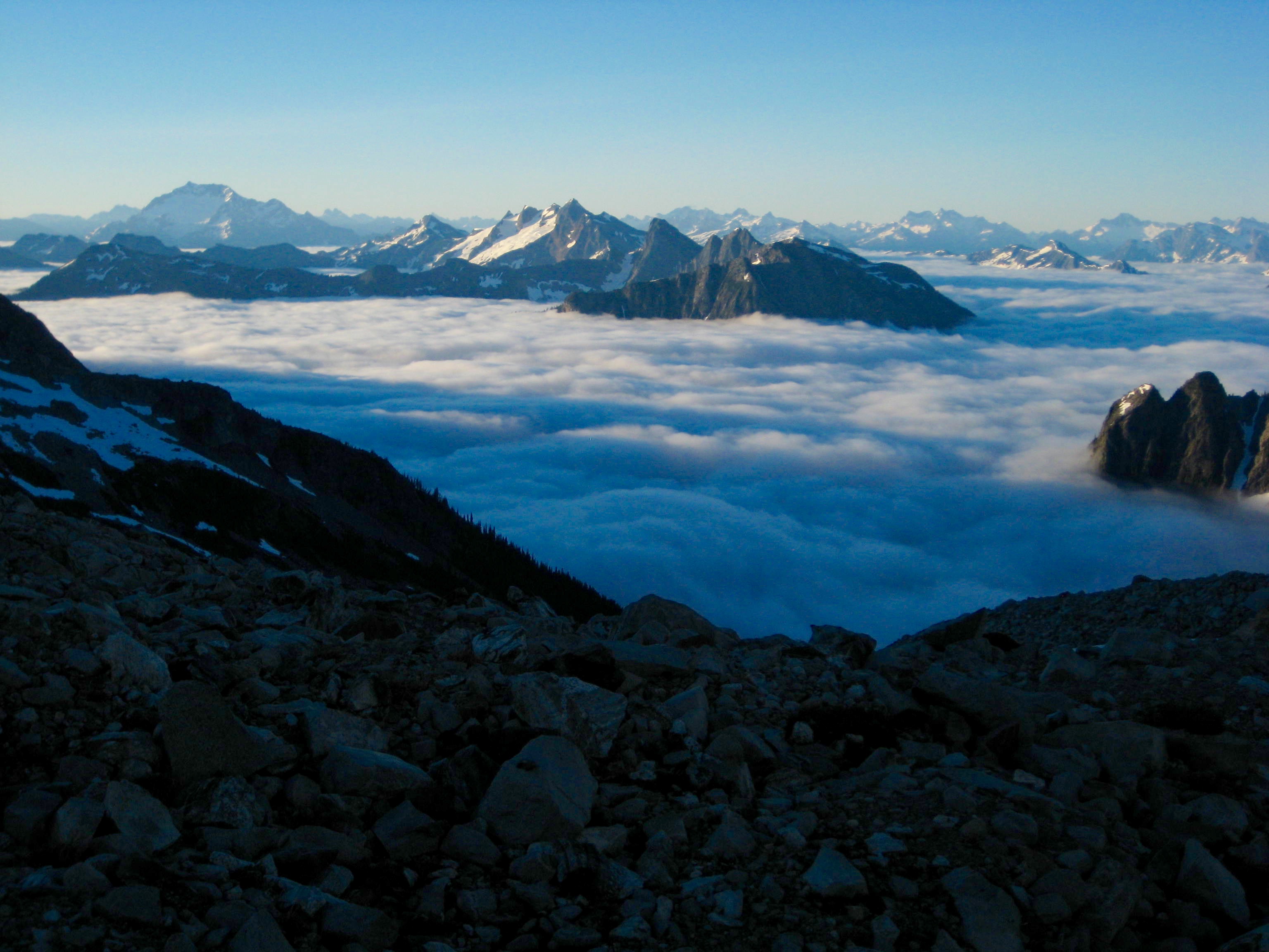 Morning light on valley fog looking toward the Picket Range as seen from the Mt Redoubt saddle