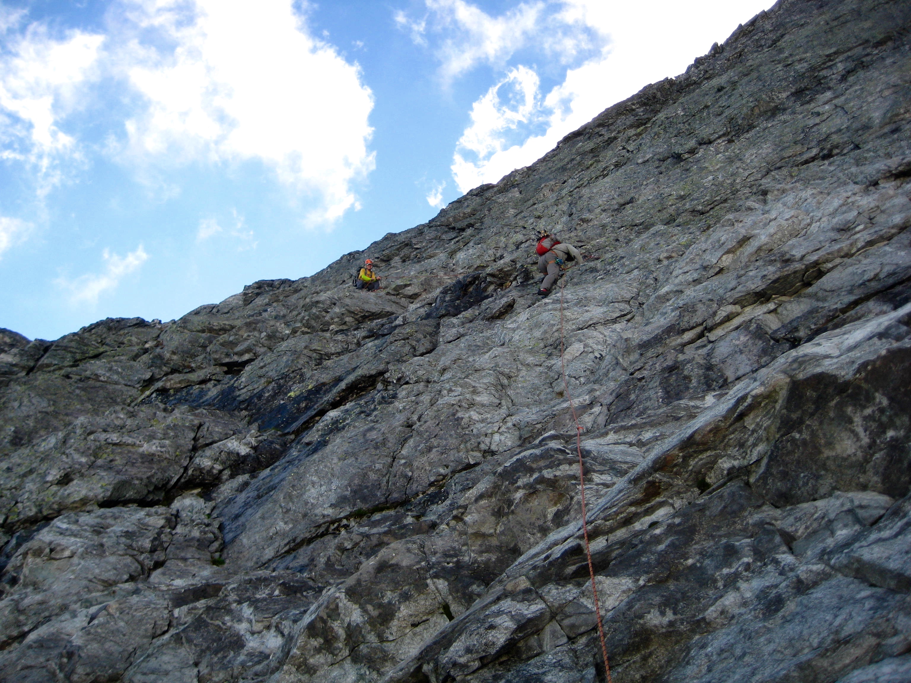 roped mountain climbers scrambling steep rock slabs on the NE ridge of Easy Mox Peak in the American Chilliwack Mountains