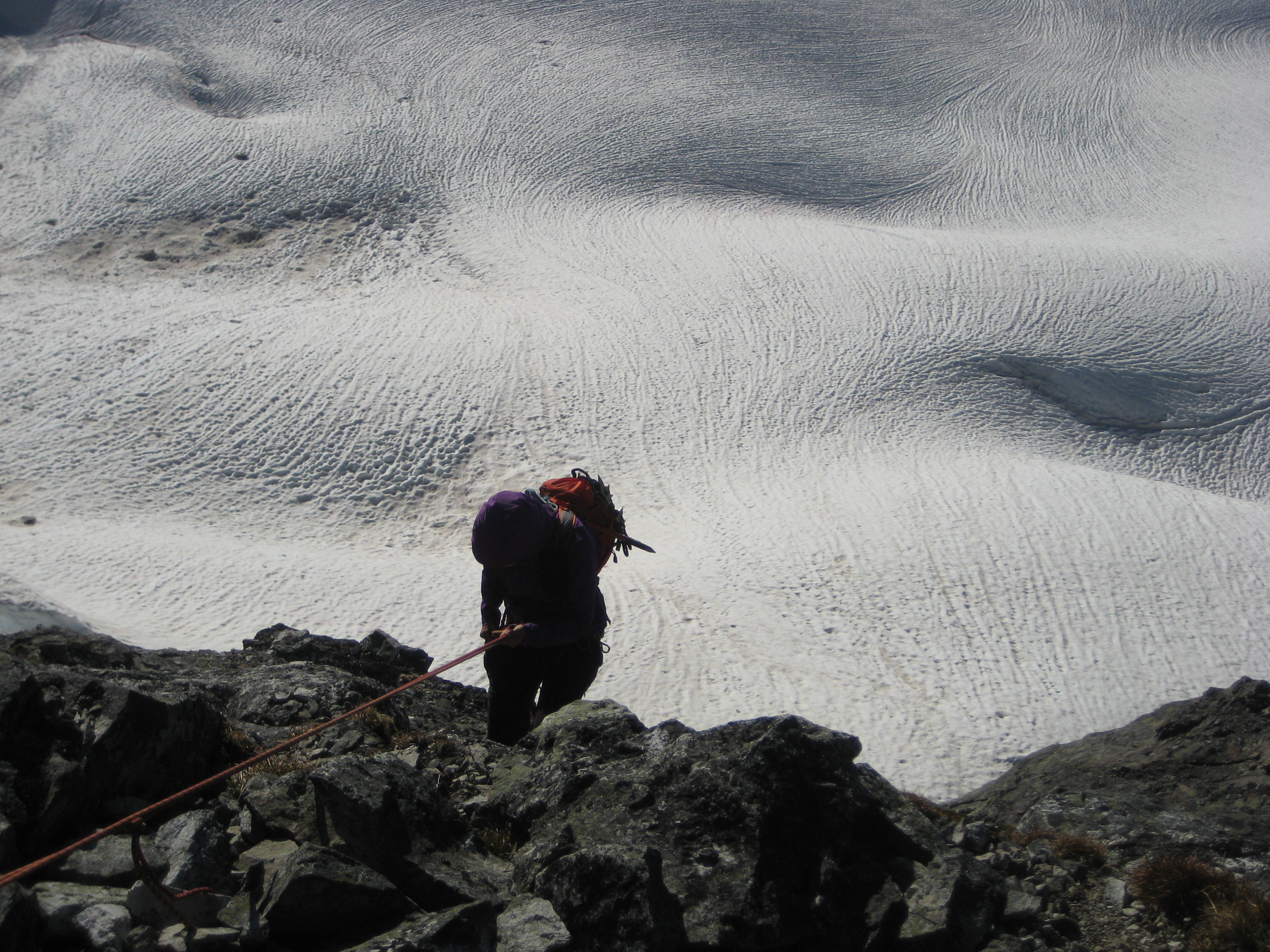 Eileen rappelling down to the Redoubt Glacier from Easy Mox Peak ridge crest
