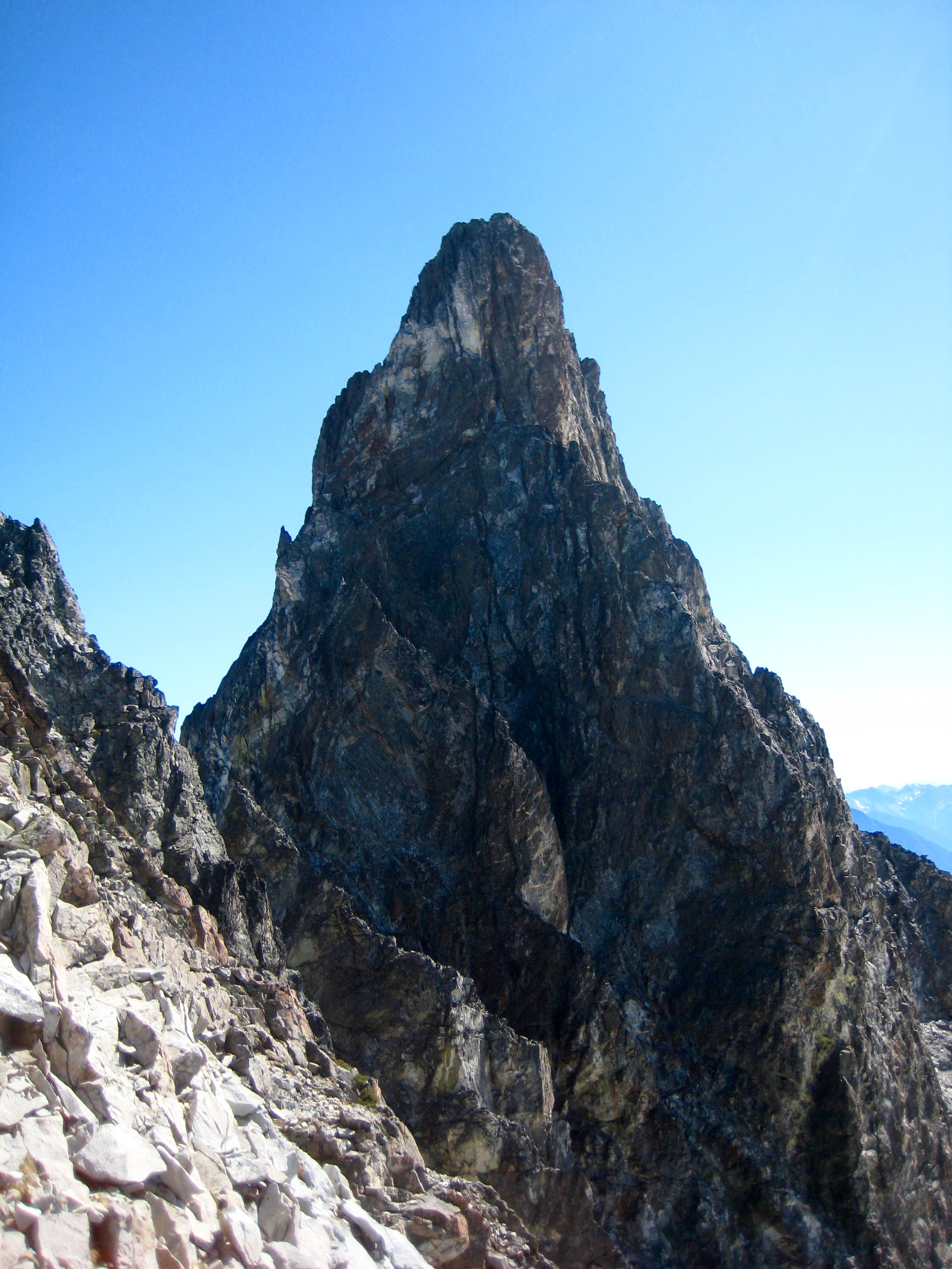 summit tower of Hard Mox Peak in the American Chilliwack Mountains as seen from notch in ridge of the Gendarme