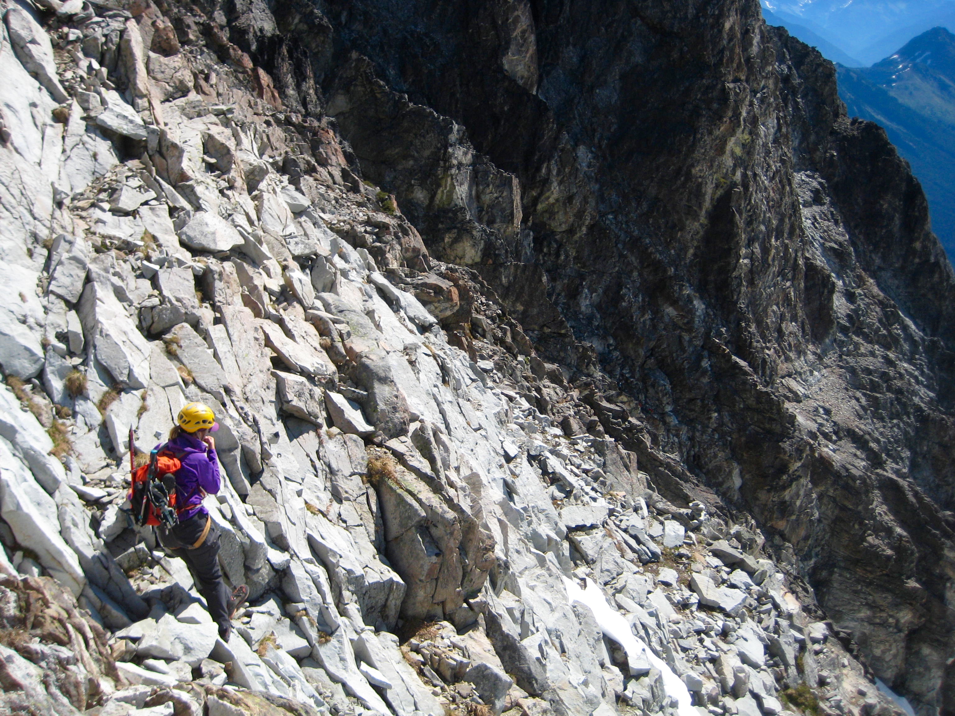 mountain climber scrambling across loose rock boulders in the American Chilliwack Mountains