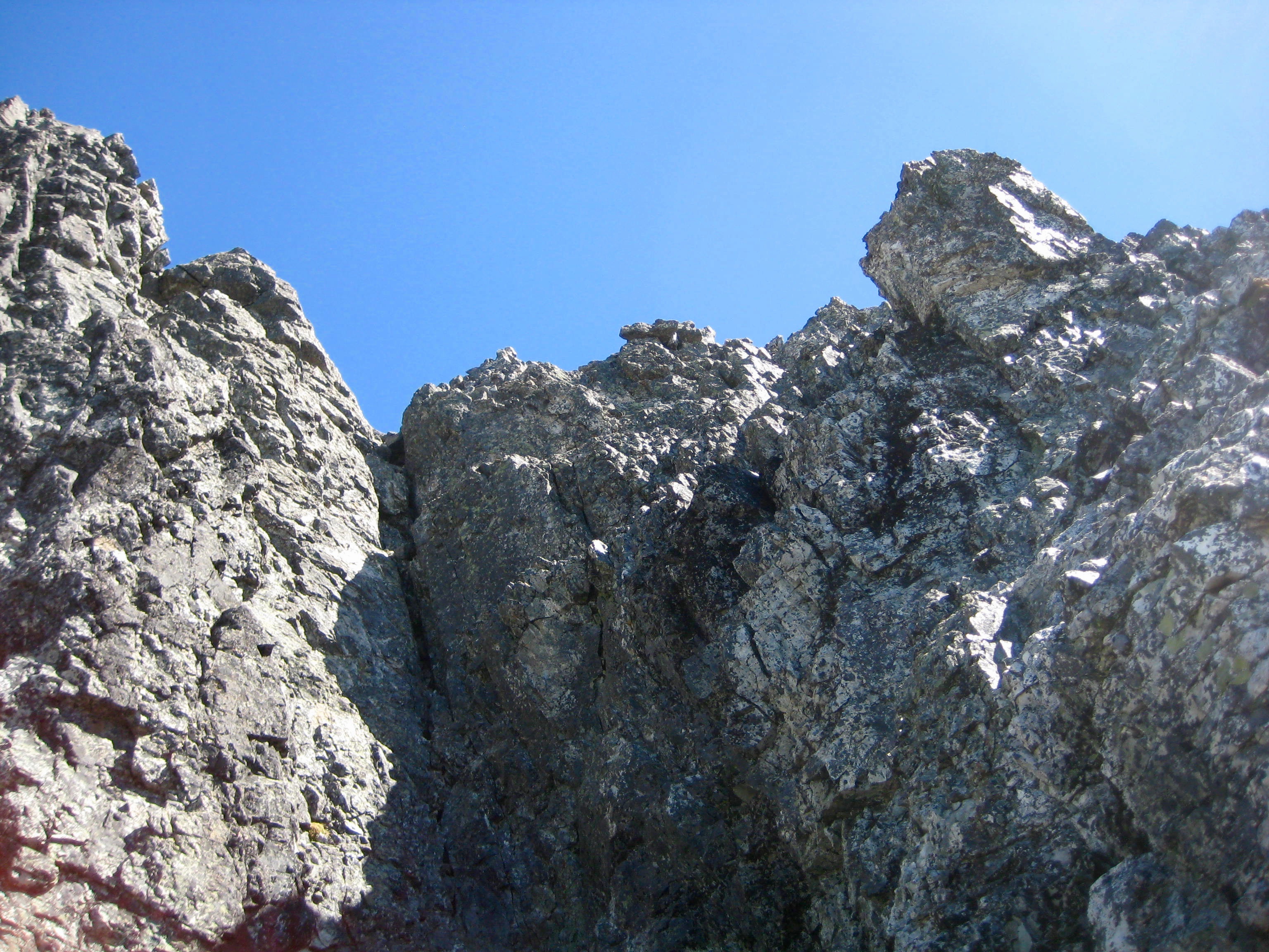 Looking up the third and final rock pitch on the summit of Hard Mox Peak