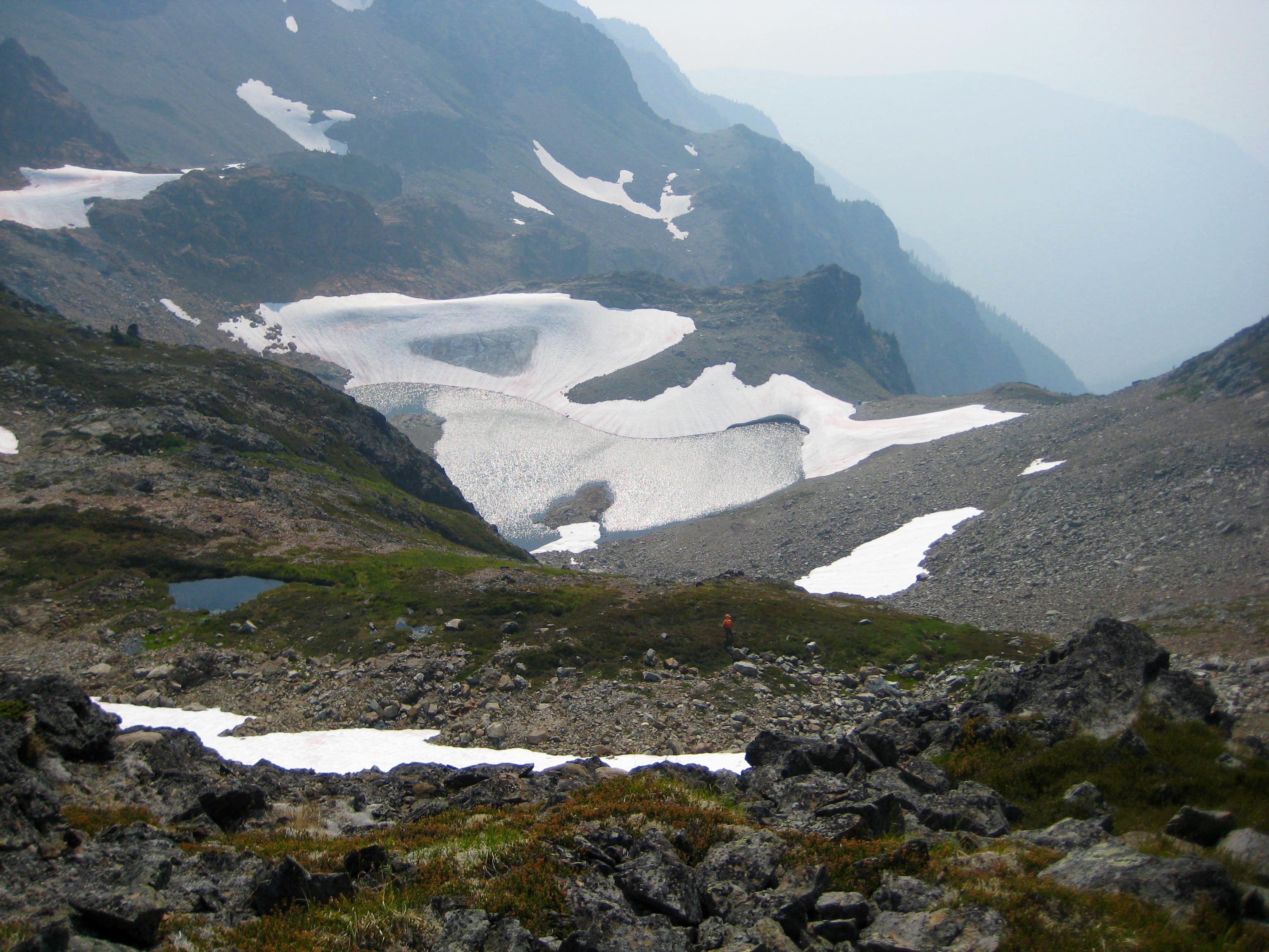 Stewart Tarn and Baby Munday Lake in the basin with snowfields