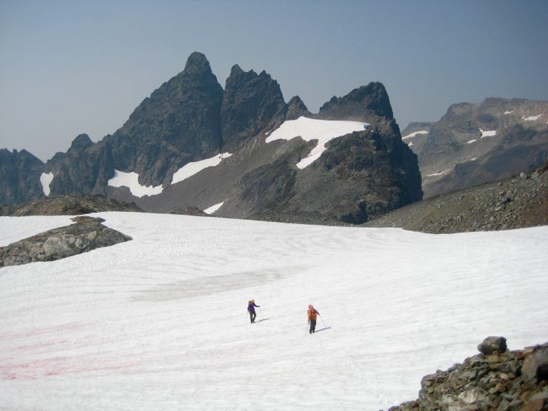Mountain climbers crossing snowfield below Baby Munday Peak taken from Stewart Peak in the Cheam Range