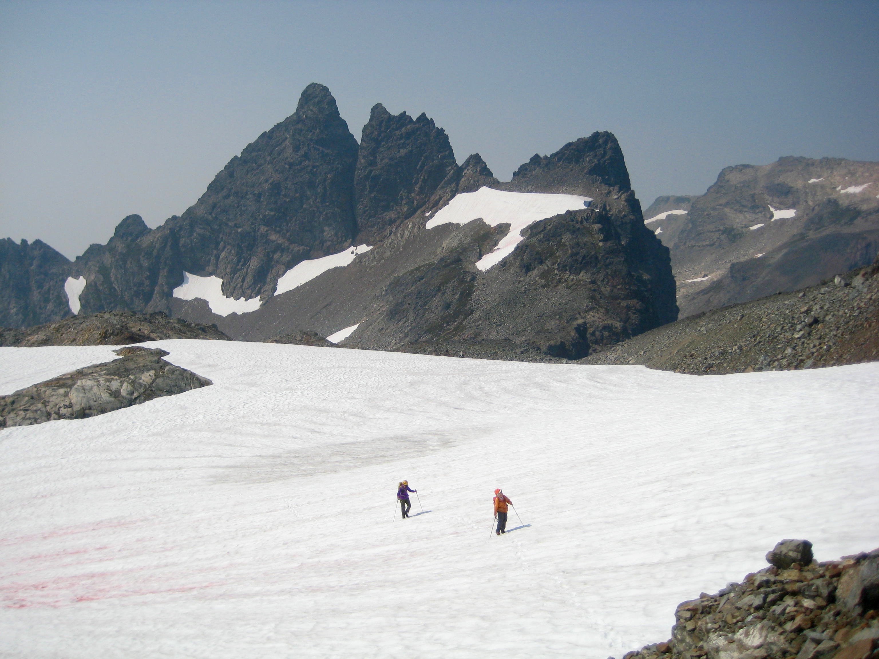 Mountain climbers crossing snowfield below Baby Munday Peak taken from Stewart Peak in the Cheam Range